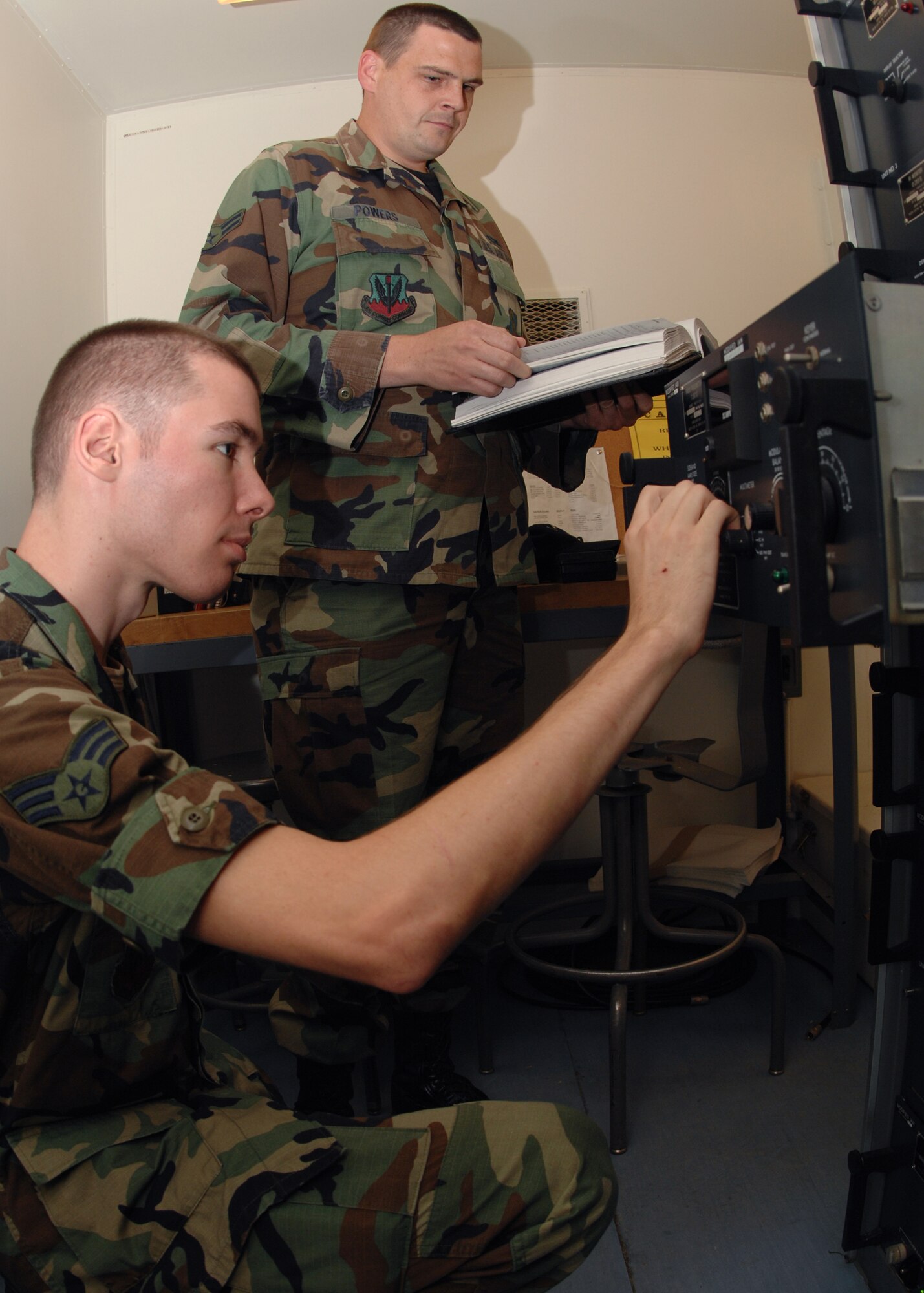 SEYMOUR JOHNSON AIR FORCE BASE, N.C. - Senior Airman Michael Ellis and Airman 1st Class Jayson Powers, airfield systems technicians, 4th Communications Squadron mission systems flight, run a systems check on a localizer June 6. Localizers provide centerline for aircraft as they approach the runway.(U.S. Air Force photo by Airman 1st Class Greg Biondo)