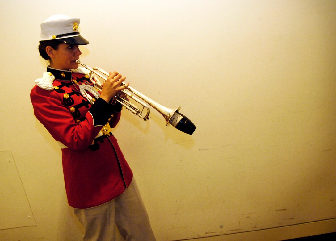 U.S. Marine Staff Sgt. Amy McCabe prepares to play "Taps" at the closing ceremony of the "Faces of the Fallen" exhibit in Arlington Va., June 7, 2007.