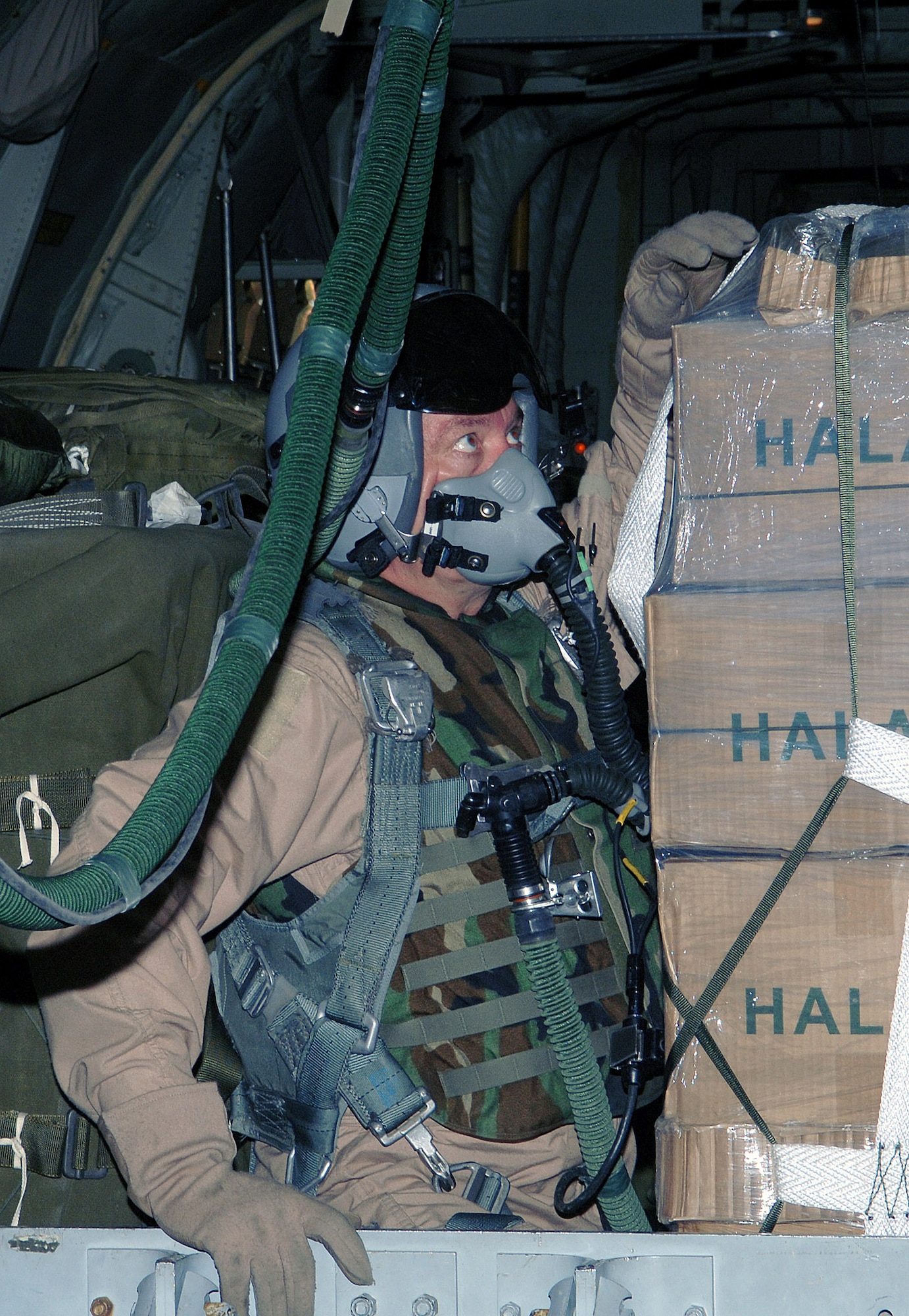 Senior Master Sgt. Doug Walton, 774th Expeditionary Airlift Squadron loadmaster, double-checks the cargo strap on a pallette of supplies during an airdrop mission above Afghanistan. Sergeant Walton is deployed from the 130th Airlift Wing, West Virginia Air National Guard. (photo by Staff Sgt. Craig Seals)