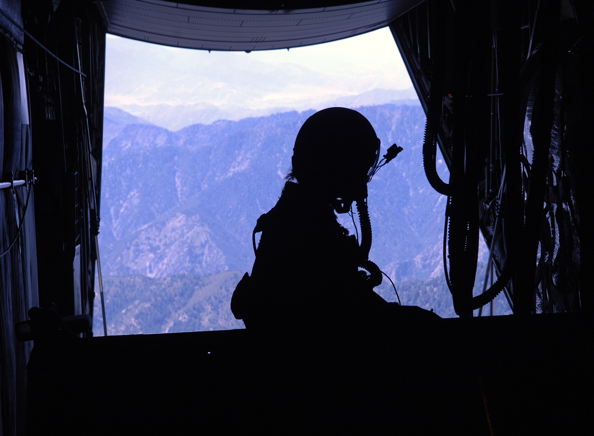 Master Sgt. Jennifer Dunaway, 774th Expeditionary Airlift Squadron loadmaster, watches as the last of her pallettes are dropped from her C-130 during an airdrop mission above Afghanistan. Sergeant Dunaway is deployed from the 130th Airlift Wing, West Virginia Air National Guard. (photo by Staff Sgt. Craig Seals)