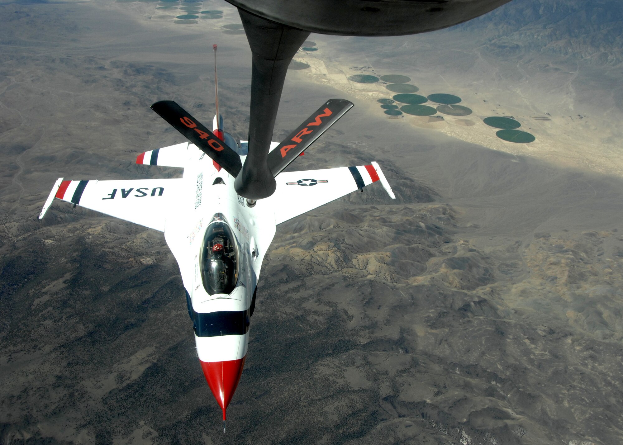An Air Force Thunderbirds F-16 Fighting Falcon prepares to receive fuel from an Air Force Reserve KC-135 Stratotanker flown by the 940th Air Refueling Wing. The tanker is based out of Beale Air Force Base, Calif. and flew a mission to refuel seven Thunderbirds over the Nevada desert.  The Thunderbirds are the main attraction for the Capital City Air Show in Sacramento June 9 and 10, which culminates Air Force Week.  The 940th ARW will also have a KC-135 flyby and static display at the show.  Air Force Week is an opportunity to inform and educate the public about the importance and role of the Air Force in America's national defense.  (U.S. Air Force photo/Randy Gon)