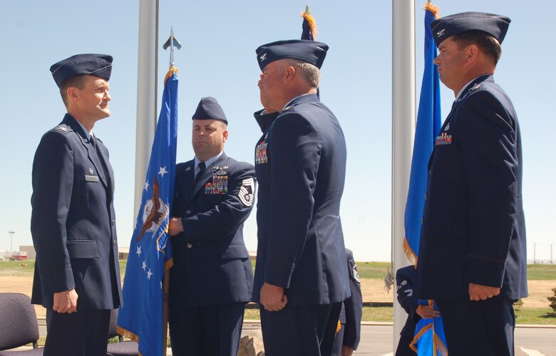 BUCKLEY AIR FORCE BASE, Colo., -- Col. Bart Hedley salutes 460th Space Wing commander Col. David Ziegler before Colonel Ziegler hands him command of the 460th Mission Support Group as former MSG commander Col. Steven Muhs watches during a ceremony June 8. Colonel Hedley came to Buckley from commanding the HQ Air Force Space Command Civil Engineer Flight, and Colonel Muhs will retire after 26 years of Air Force service. (U.S. Air Force photo by Senior Airman Jacque Lickteig)