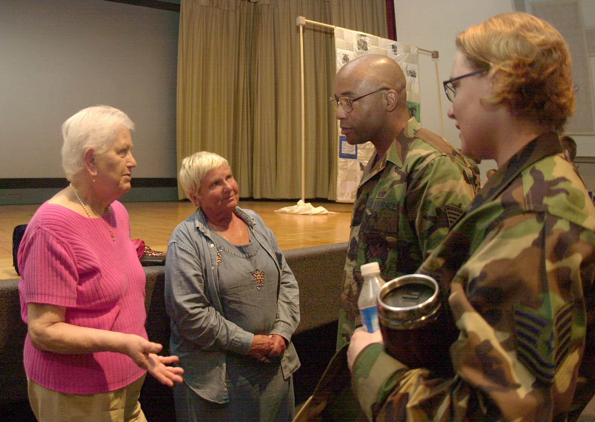 From left to right: Rosa Freund, a survivor of Auschwitz-Birkenau concentration camp, and Wanda Wolosky, a survivor of the Warsaw Ghetto, talk to guests who attended one of the History of the Holocaust presentations Thursday at the base theater. (U.S. Air Force photo by Airman 1st Class Luis Loza Gutierrez).