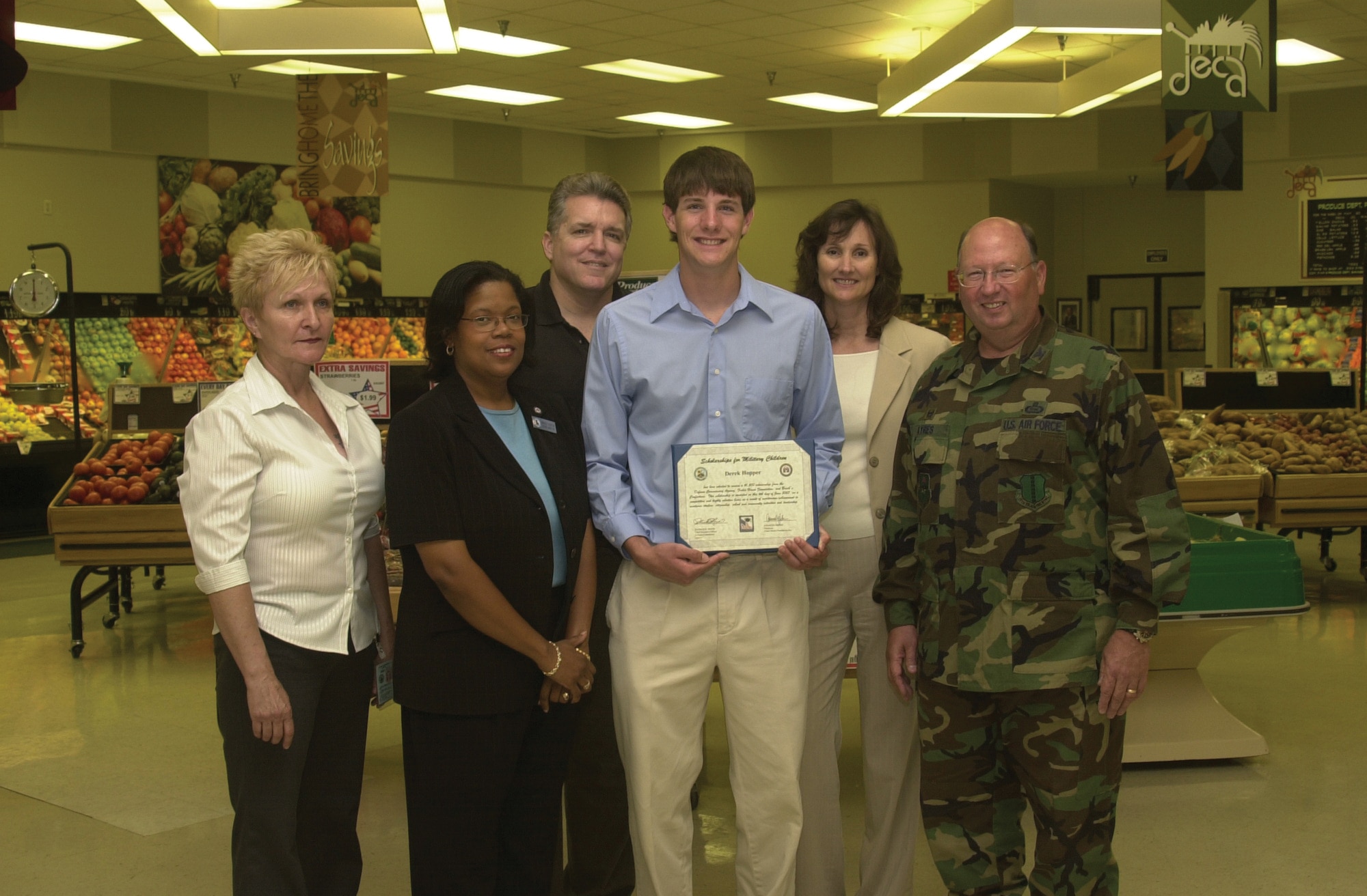 Front row from left to right: Mabel Snider, Sarvis district manager; Kimberly Houston, Commissary store manager; Derek Hopper, scholarship recipient and Col. Richard Ayres, 17th Training Wing commander, pose for a group photo after a scholarship presentation ceremony Wednesday at the Goodfellow Commissary. Bryan and Joy Hopper stand behind their son Derek.  (Air Force photo by Airman 1st Class Luis Loza Gutierrez.)