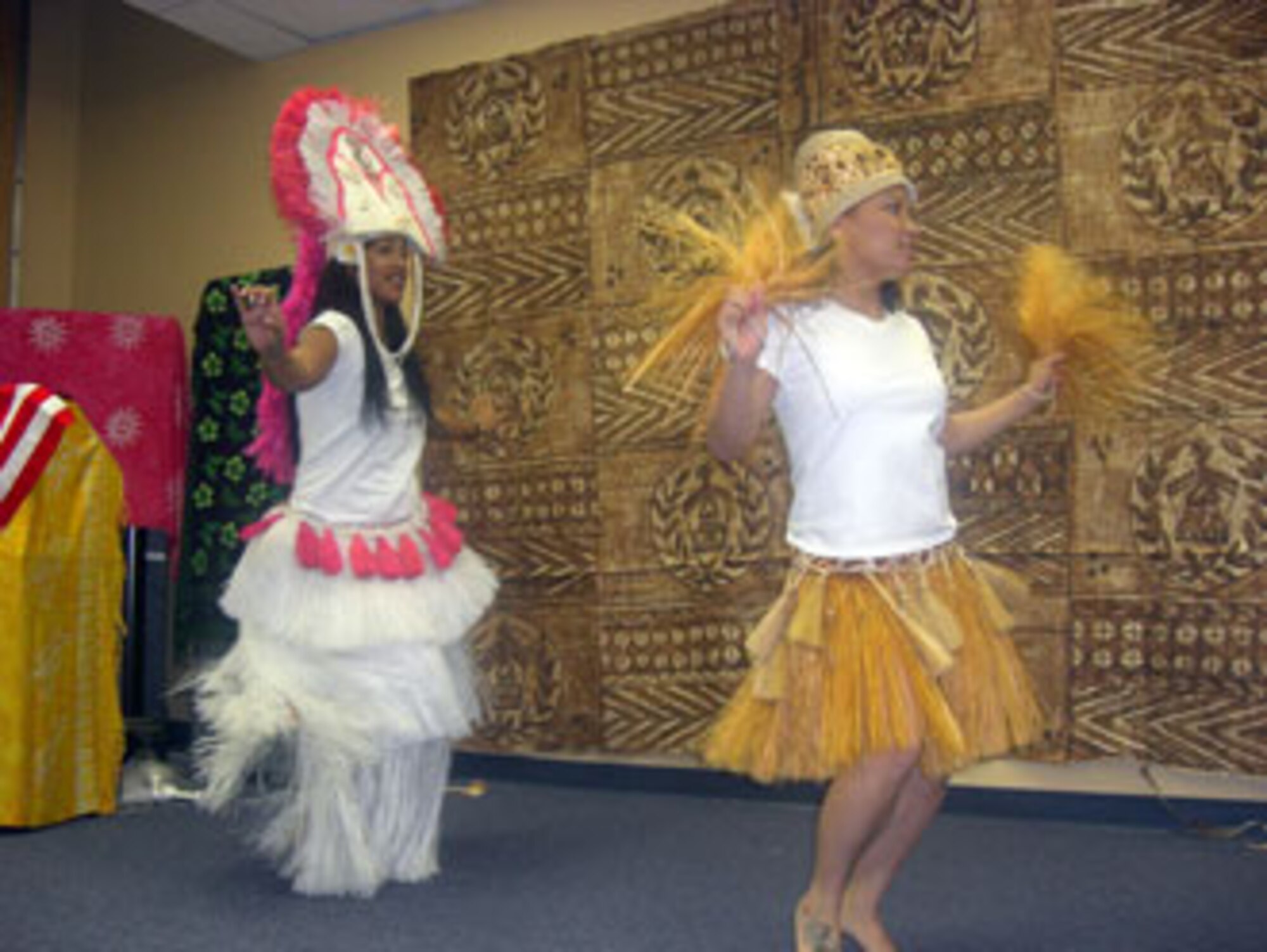 Army Sgt. Mele Semo and Specialist Cat Mai demonstrate a traditional Tahitian dance.  The Army Reserve’s 304th Sustainment Brigade held a luncheon at March Air Reserve Base celebrating Asian Pacific Islander month May24. (U.S. Army photo by Specialist Tracy Ellingsen)