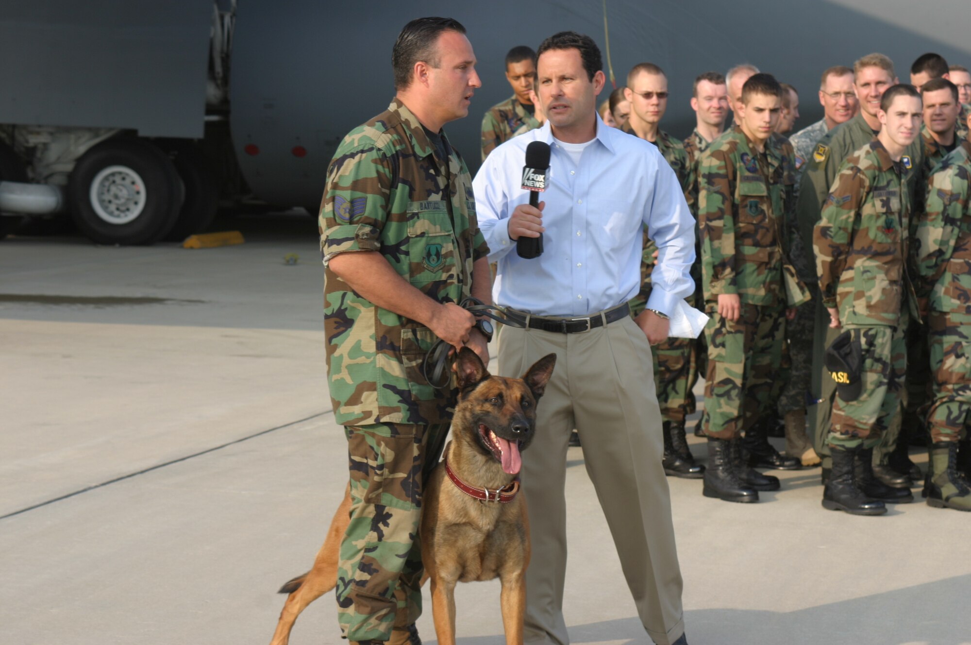During one live segment from Wright-Patterson Air Force Base, Ohio, "FOX and Friends" co-anchor Brian Kilmeade talks with Staff Sgt. Christopher Bartucci from the 88th Security Forces Squadron military working dog section. A demonstration in which Sergeant Bartucci and his dog, Houby, detained a “fleeing suspect” was broadcast live. (Air Force photo by Master Sgt. Doug Moore)