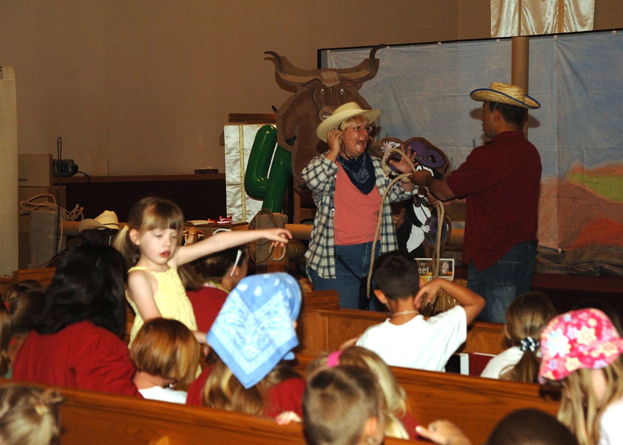 Nearly 100 children watch on during their daily Bible lesson at Vacation Bible School. In addition to Bible lessons, the children also enjoyed various games, arts and crafts and singing. (U.S. Air Force photo by Airman 1st Class Tiffany Mayo)