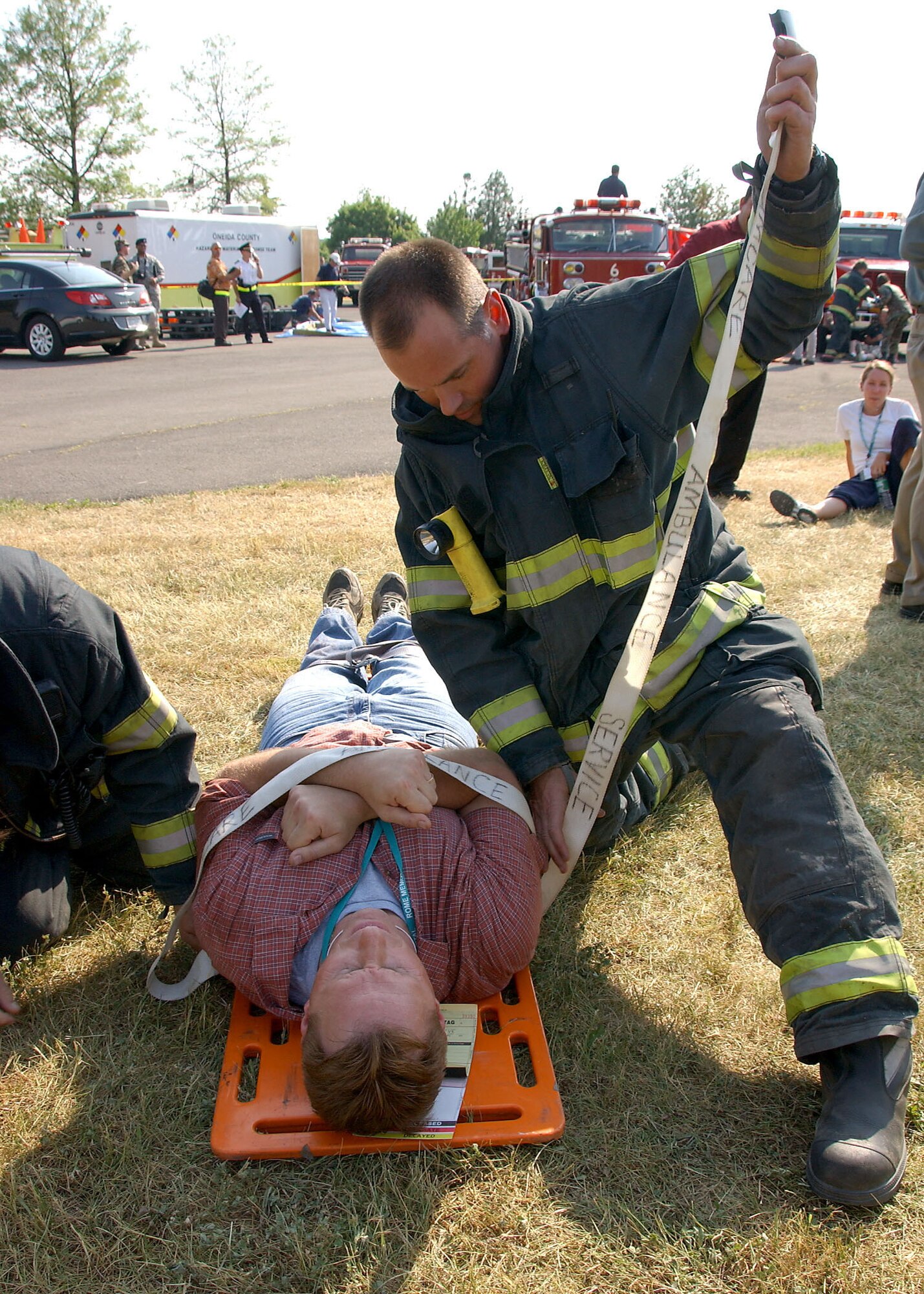 A Rome Fire Department firefighter works to stabilize Northeast Air Defense Sector simulated victim during the Griffiss Park Mass Casualty Exercise Thursday. The exercise challenged first responders to perform their triage and hazmat procedures on victims of a simulated terrorist attack.  Photo by Senior Airman Ricky Best