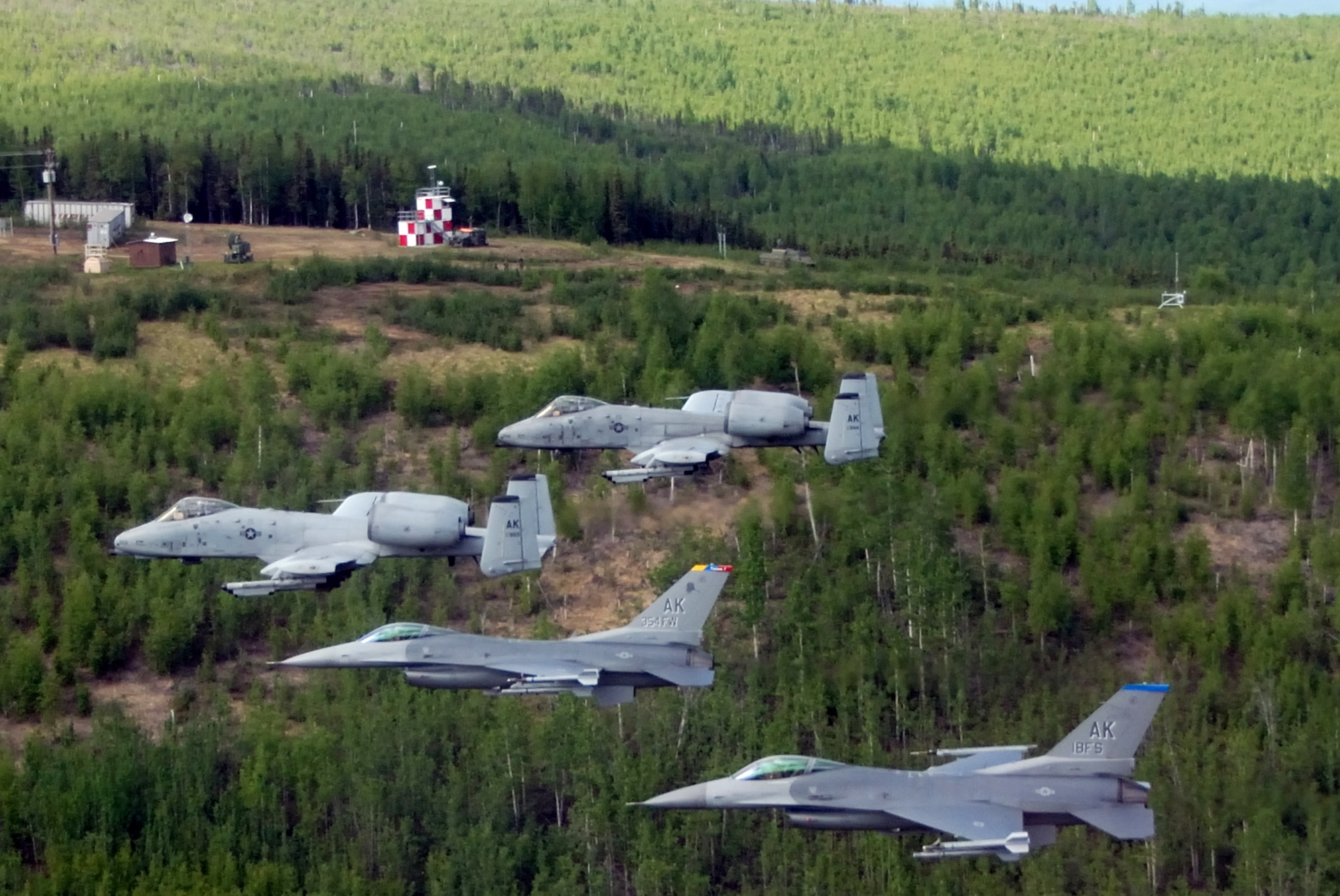 Two F-16 Fighting Falcons from the 18th Fighter Squadron and two A-10 Thunderbolt IIs from the 355th Fighter Squadron fly May 29 over the Pacific Alaska Range Complex in Alaska. The aircraft assigned to Eielson Air Force Base, Alaska, flew in formation for the last time due to the deactivation of the 18th and 355th Fighter Squadrons. (U.S. Air Force photo/Master Sgt. Rob Wieland)
