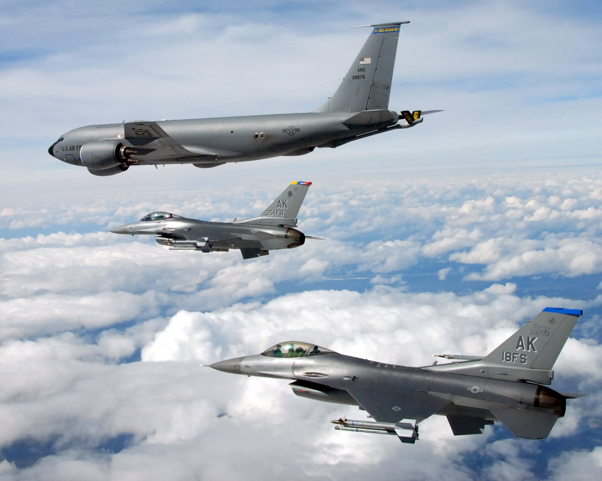 A KC-135 Stratotanker from the Alaska Air National Guard's 168th Air Refueling Wing flies in formation with two F-16 Fighting Falcons from the 18th Fighter Squadron May 29 over Alaska. The three aircraft assigned to Eielson Air Force Base, Alaska, flew in formation for the last time due to the deactivation of the 18th and 355th Fighter Squadrons. (U.S. Air Force photo/Master Sgt. Rob Wieland)
