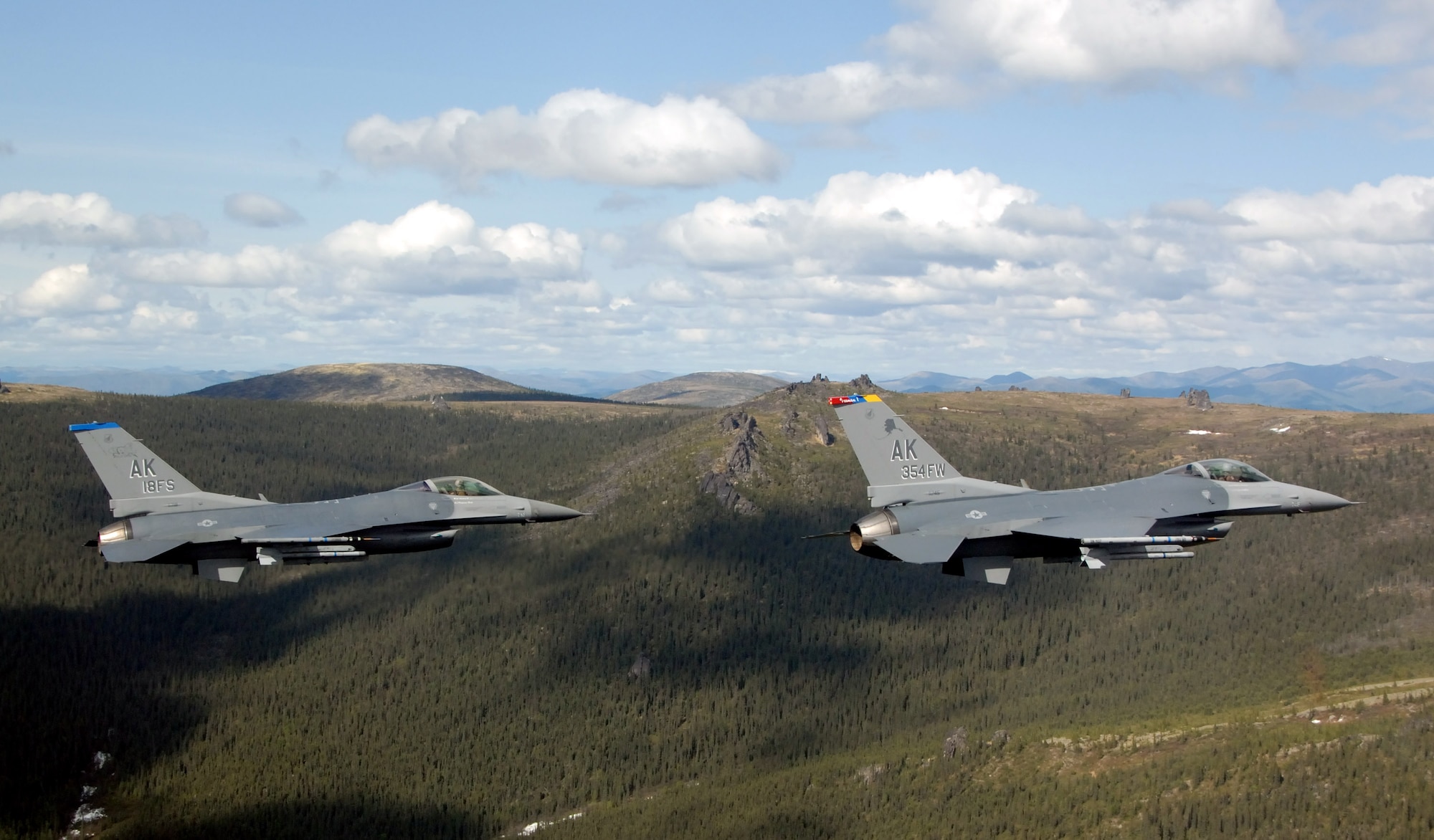 Two F-16 Fighting Falcons from the 18th Fighter Squadron fly May 29 over the Pacific Alaska Range Complex in Alaska. The aircraft assigned to Eielson Air Force Base, Alaska, flew in formation for the last time due to the deactivation of the 18th and 355th Fighter Squadrons. (U.S. Air Force photo/Master Sgt. Rob Wieland)


