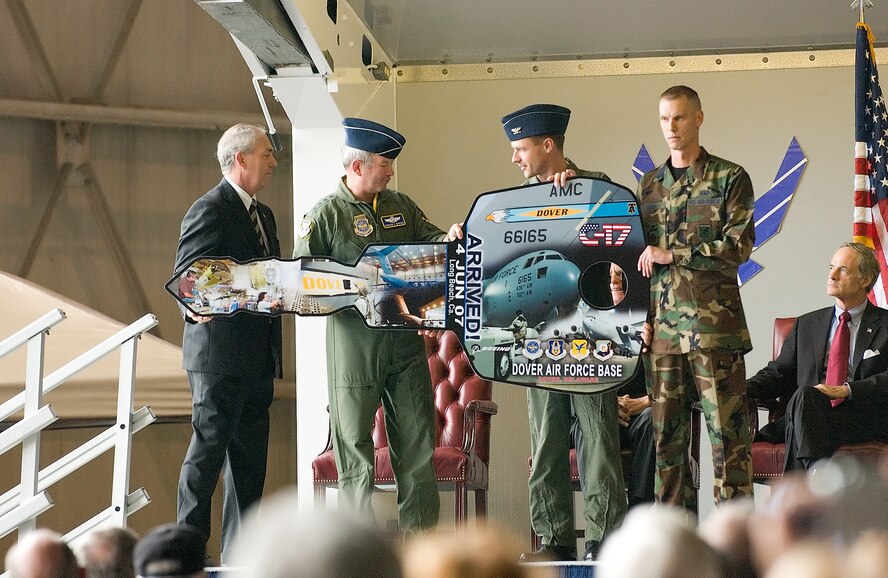 DOVER AIR FORCE BASE, Del. -- Ronald Marcotte, Boeing vice president, presents Gen. Duncan McNabb, Air Mobility Command commander, Col. Steven Harrison, 436th Airlift Wing commander and Staff Sgt. Lance Moon, 736th Aircraft Maintenance Squadron crew chief, the ceremonial ‘key’ to the Spirit of the Constitution in an arrival ceremony here June 4. The aircraft is the first of 13 C-17 Globemaster IIIs Dover AFB is to recieve over the next year. (U.S. Air Force photo/Jason Minto)