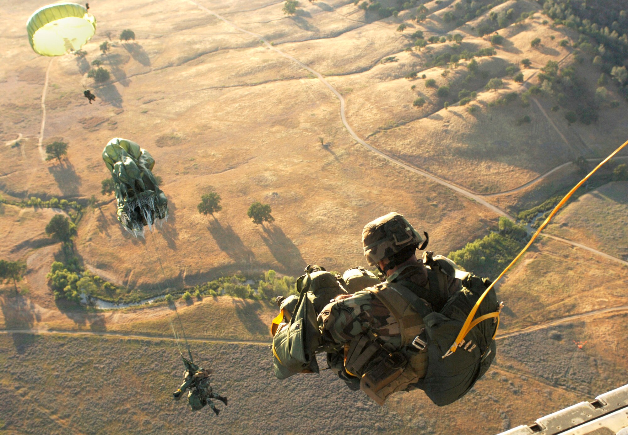 Airmen jump from a C-130 Hercules June 2 during an airdrop in support of Operation Hydra, a weeklong exercise. The exercise was held to test the 615th Contingency Response Wing's ability to conduct expeditionary mobility operations at three locations. (U.S. Air Force photo/Staff Sgt. Sarayuth Pinthong) 