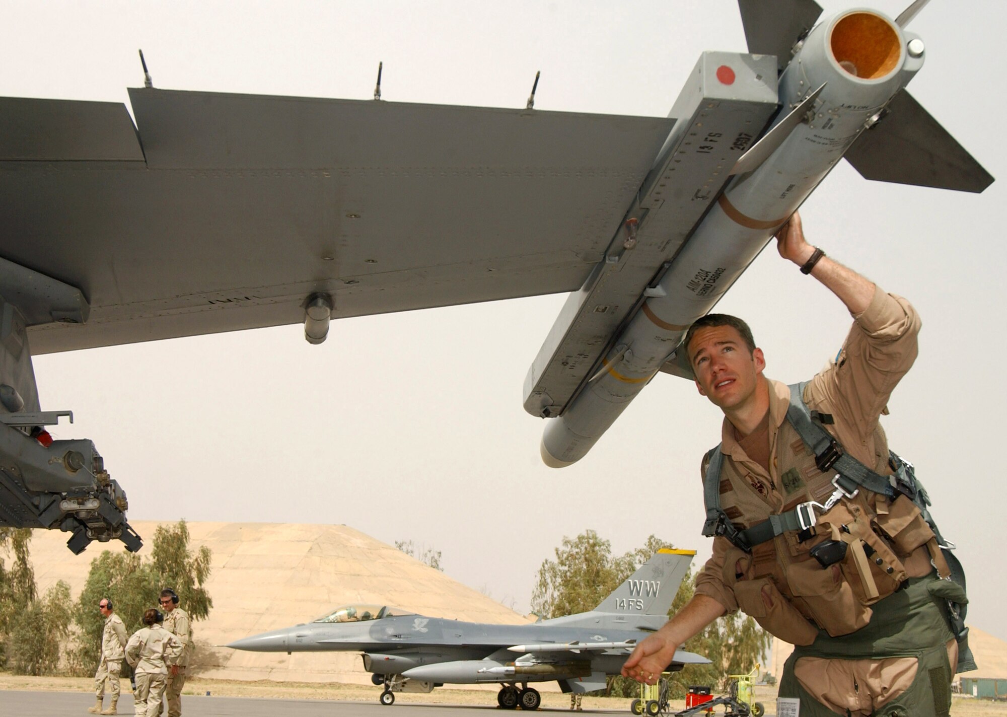 Capt. Bryan Spence pre-flights his F-16 Fighting Falcon May 30 at Balad Air Base, Iraq, before a combat mission. Assigned to the 14th Expeditionary Fighter Squadron, he is deployed from the 14th Fighter Squadron at Misawa Air Base, Japan. (U.S. Air Force photo/1st Lt. Shannon Collins)                        