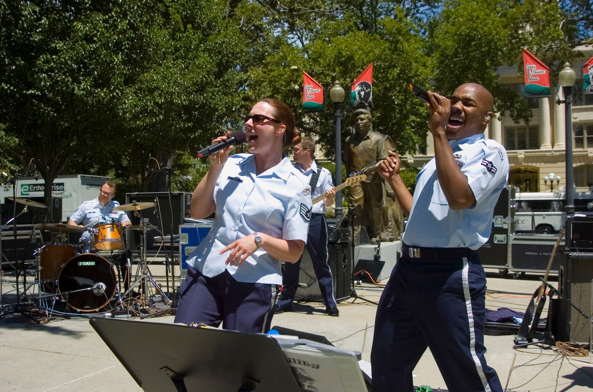 Staff Sgt. Paula Goetz and Airman 1st Class Andrew Jones of the Air Force Band of the Golden West from Travis Air Force Base, Calif., perform in the Cesar Chavez Plaza as part of Air Force Week June 7 in Sacramento, Calif. Sergeant Goets and Airman Jones are vocalists.  Also performing are Staff Sgt. Troy Griffin on the drums and Senior Airman Jason Hafer on the bass guitar. (U.S. Air Force photo/Staff Sgt. Joseph Prouse) 