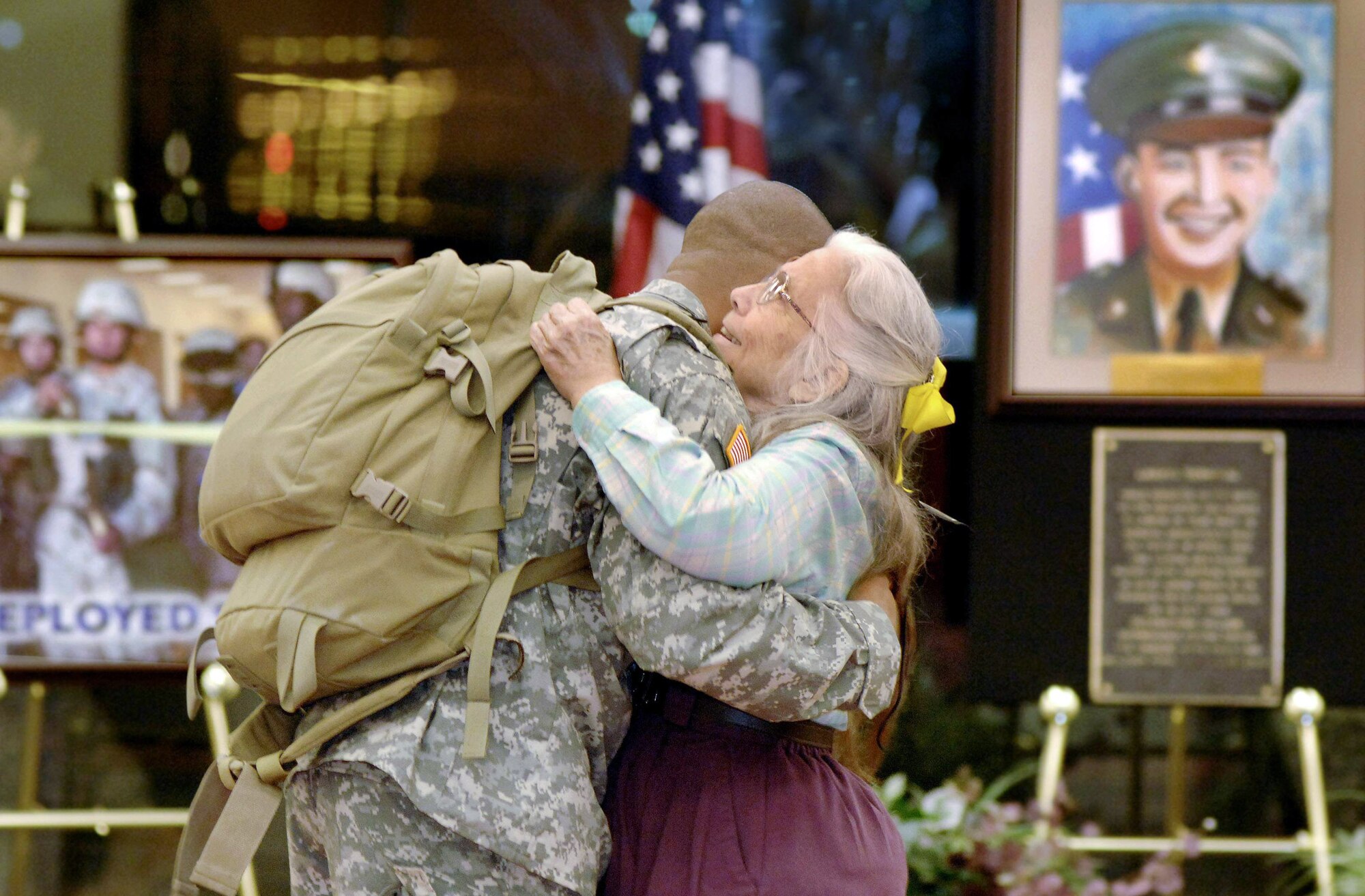 Elizabeth Laird, a Salvation Army volunteer, gives Capt. Adrian Williams a hug following his return from a six-month deployment to Iraq June 5 at Fort Hood, Texas. Ms. Laird has been giving Soldiers and Airmen departing and returning to Fort Hood hugs for more than four years. (U.S. Air Force photo/Daren Reehl)