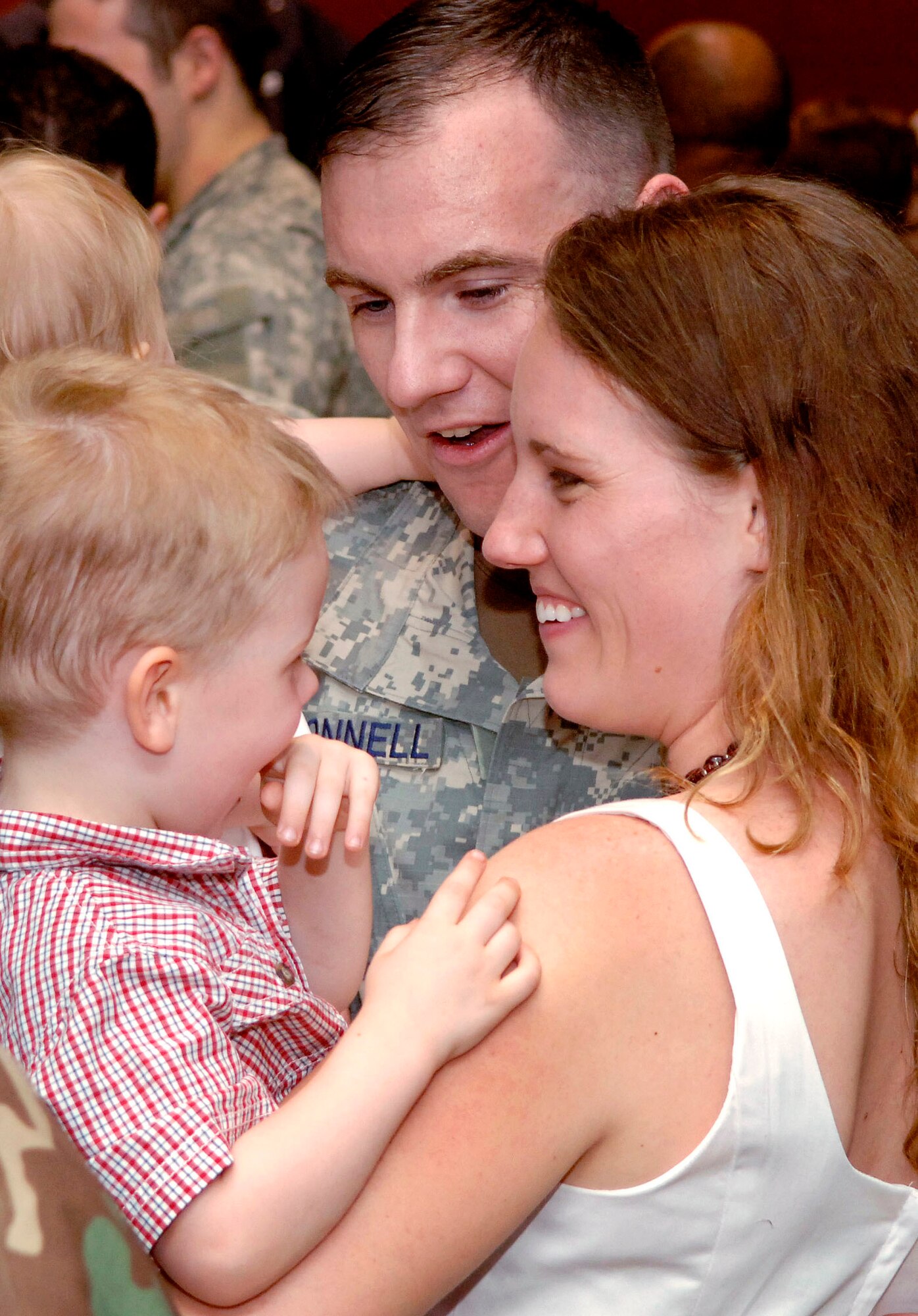 Capt. Brendan O'Donnell gets a welcome home from his wife, Jennifer, his 2-year-old son, Colin, and 10-month-old daughter, Emma, after returning June 5 to Fort Hood, Texas, following a six-month deployment to Iraq. Captain O'Donnell is one of nearly 90 Airmen from the 3rd Air Support Operations Group who returned back home following a deployment that spread them out across forward operating bases throughout Iraq. (U.S. Air Force photo/Daren Reehl) 
