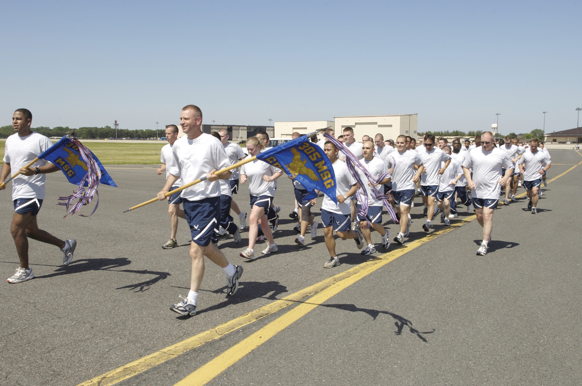 The 305th Communications Squadron runs in formation on the flight line during the Joint Base Warrior Run May 30. The run featured members of Fort Dix, Lakehurst and McGuire running 2.6 miles on runway 360. (U.S. Air Force photo by Kenn Mann) 