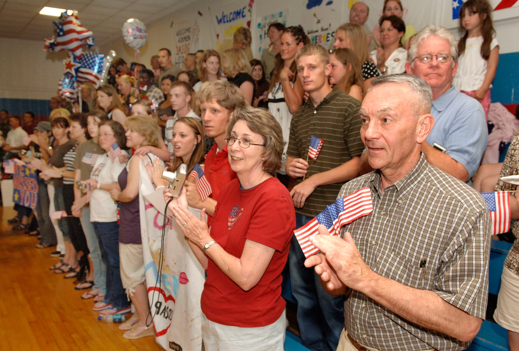 Parents and family members applaud as their sons, daughters, spouses and parents enter a gym following the return of battlefield Airmen from the 3rd Air Support Operations Group June 5 at West Fort Hood, Texas. The Airmen spent the past six months supporting Army combat brigades with close-air and overwatch support. (U.S. Air Force photo/Daren Reehl) 
