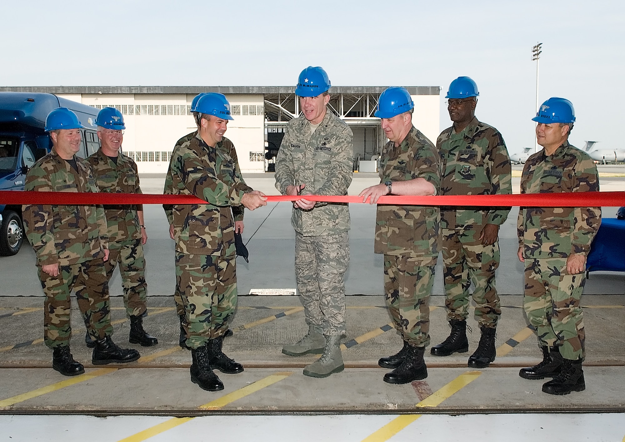 DOVER AIR FORCE BASE, Del. -- Brig. Gen. Robert McMahon, Air Mobility Command director of logistics (center), is flanked by Team Dover commanders and AMC officials as he cuts the ribbon at the new Regionalized Isochronal Inspection Dock June 1. Dover Air Force Base’s ISO Dock is the first-ever Regionalized Isochronal Inspection Facility in the Air Force. (U.S. Air Force photo/Jason Minto)