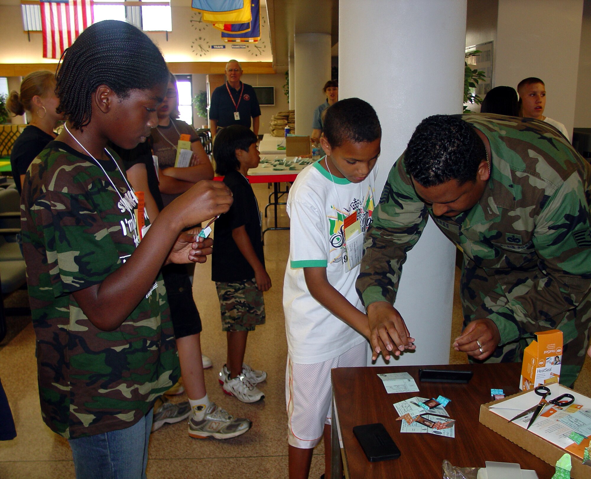 Tech. Sgt. Carlos Torres, 305th Security Forces Squadron NCO in charge of badging, fingerprints sixth graders from the North Hanover School district as they prepare to "deploy" to Camp Camel at the pax terminal here June 8.