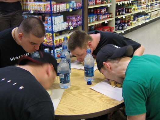 One of the events at Airman's Night at the Commissary May 20 was a sub sandwich eating contest where competitors had to eat a six-inch sub without using their hands. The winner was presented with a gift certificate. (U.S. Air Force photo by Susi Schamp)