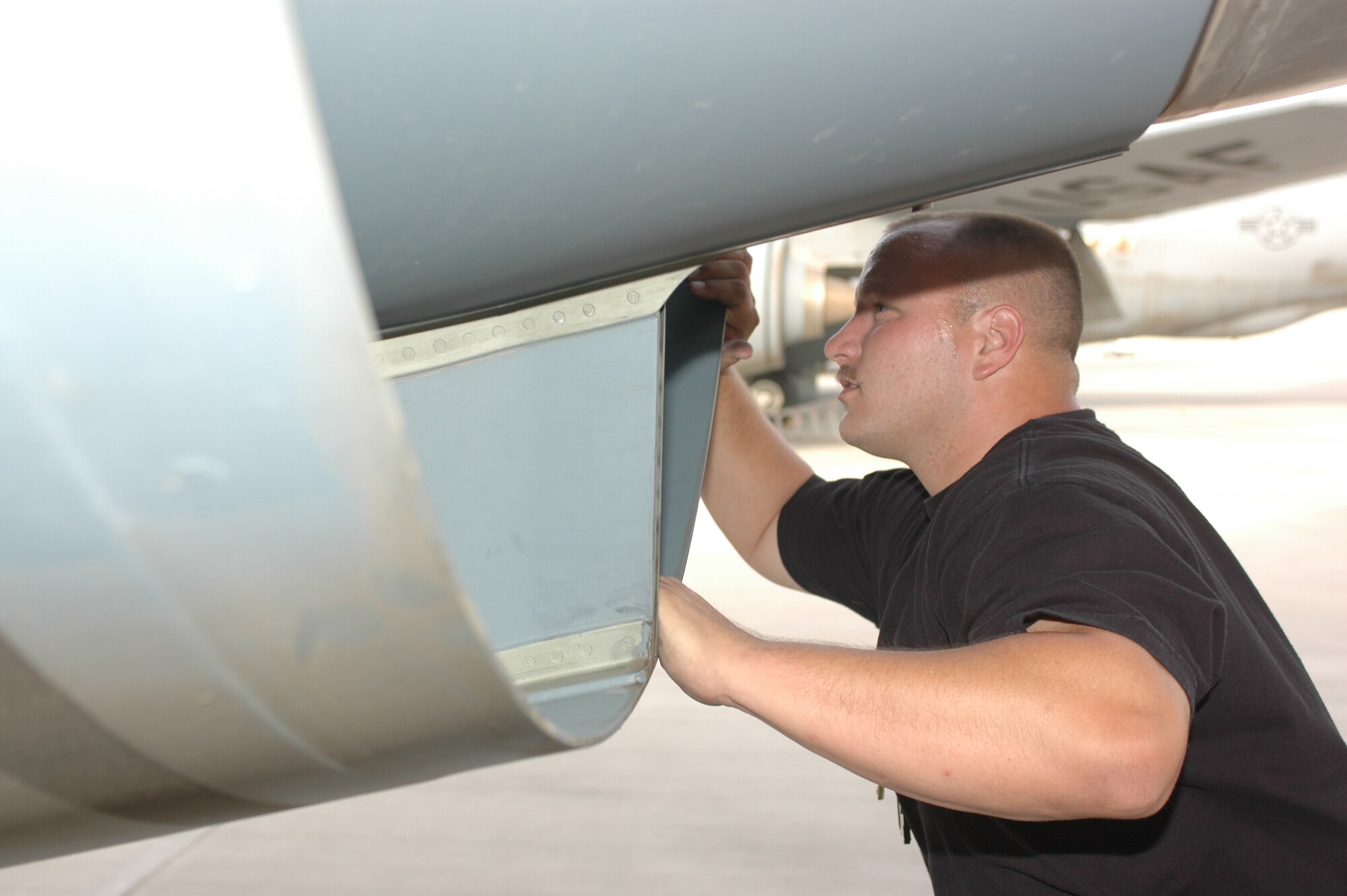Staff Sgt. Jason Riker, 340th Aircraft Maintenance Unit, 379th  Expeditionary Aircraft Maintenance Squadron, conducts a post-flight inspection on a  KC-135 to make sure everything is in working order. (Photo by Senior Airman Clark Staehle)