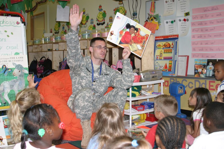 Army Pfc. Patrick Baker, DARE officer, interacts with kindergarten students during a class on general safety practices at Kadena Air Base, Japan. Military police members from the Army, Navy and Marines taught students at base schools May 17 the skills they need to avoid involvement in drugs, gangs, and violence. The classes were taught as part of the Drug Abuse Resistance Education program.
(U.S. Air Force/Senior Airman Nestor Cruz)