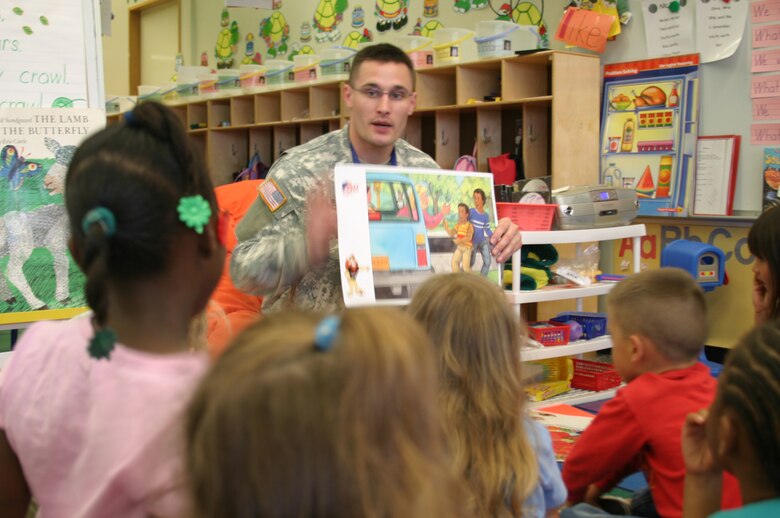 Army Pfc. Patrick Baker, DARE officer, shows kindergarten students a visual aid depicting a potentially dangerous situation at Kadena Air Base, Japan. Military police members from the Army, Navy and Marines taught students at base schools May 17 the skills they need to avoid involvement in drugs, gangs, and violence. The classes were taught as part of the Drug Abuse Resistance Education program.
(U.S. Air Force/Senior Airman Nestor Cruz)
