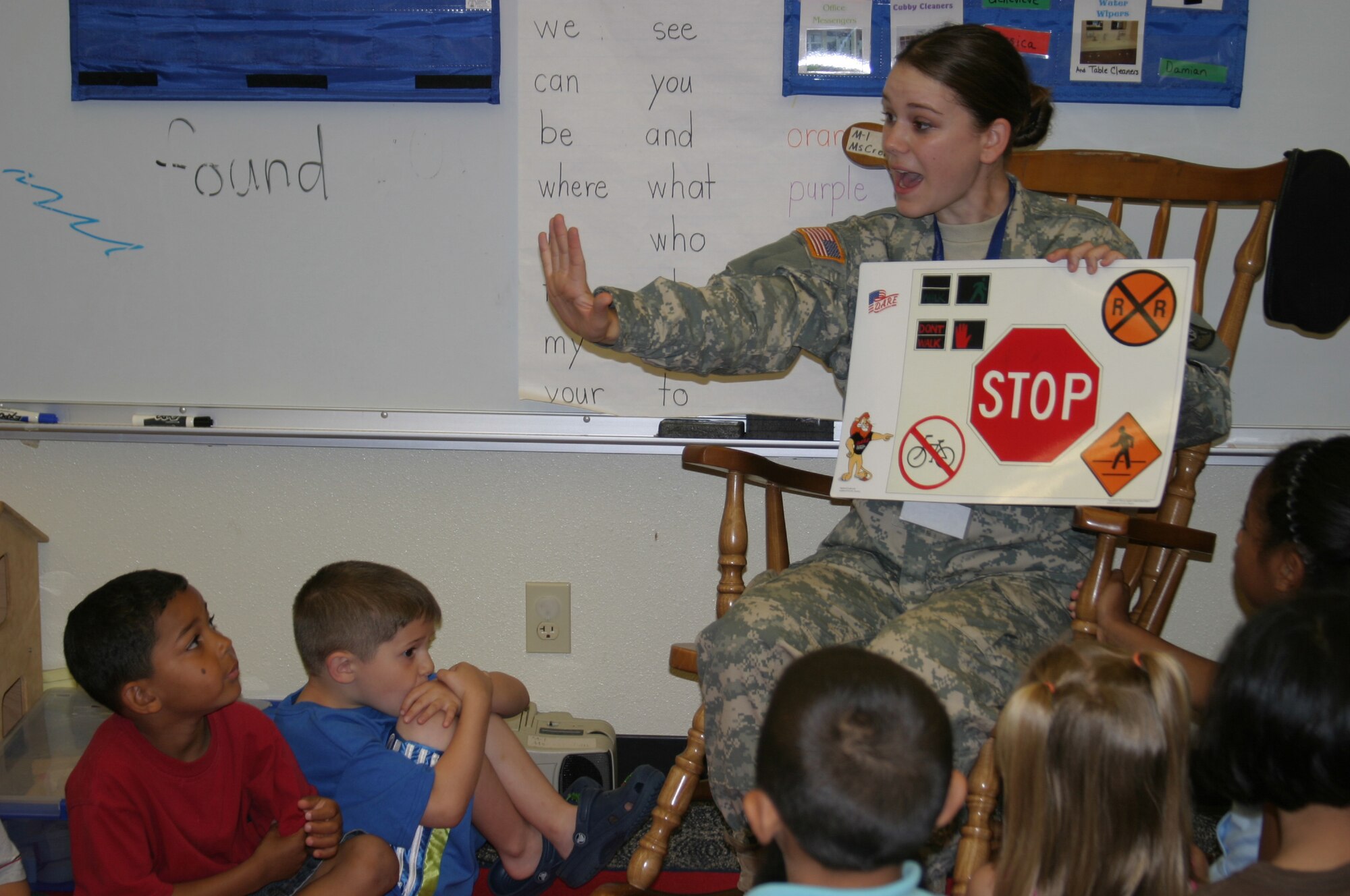Army Pvt. Brandy Yocum, DARE officer, shows kindergarten students a visual aid depicting various traffic signs. Military police members from the Army, Navy and Marines taught students at Kadena Air Base, Japan, schools May 17 the skills they need to avoid involvement in drugs, gangs, and violence. The classes were taught as part of the Drug Abuse Resistance Education program.
(U.S. Air Force/Senior Airman Nestor Cruz)
