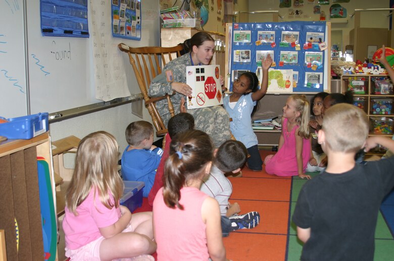 Army Pvt. Brandy Yocum, DARE officer, shows kindergarten students a visual aid depicting various traffic signs. Military police members from the Army, Navy and Marines taught students at Kadena Air Base, Japan, schools May 17 the skills they need to avoid involvement in drugs, gangs, and violence. The classes were taught as part of the Drug Abuse Resistance Education program.
(U.S. Air Force/Senior Airman Nestor Cruz)
