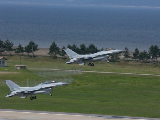 KUNSAN AIR BASE, Republic of Korea --Two F-16s from the 111th Fighter Squadron take off during a joint training exercise with members of the 8th Fighter Wing here June 8. This is the first time since the 111th FS moved here that the two units have briefed, flown and debriefed together on a dedicated mission. (U.S. Air Force photo by Staff Sgt. Darcie Ibidapo)     
