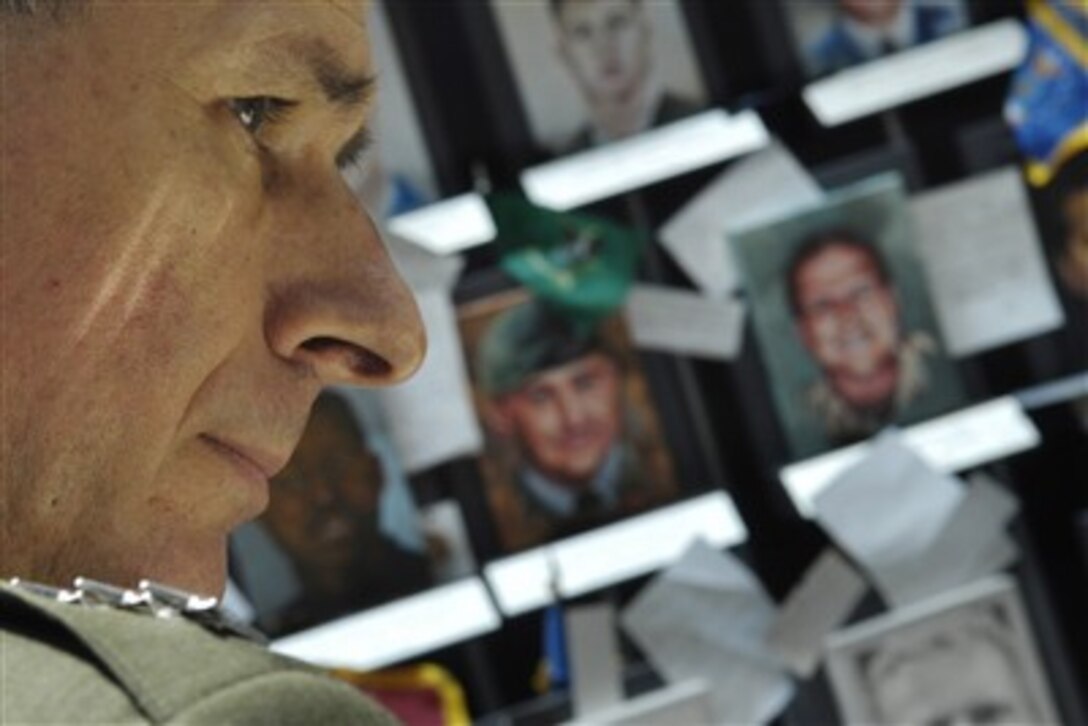 Chairman of the Joint Chiefs of Staff Gen. Peter Pace, U.S. Marine Corps, tours the Faces of the Fallen exhibit in Arlington, Va., on June 7, 2007.  The exhibition opened in 2005 and consists of 1,319 painted portraits of U.S. service members killed in Afghanistan and Iraq.  