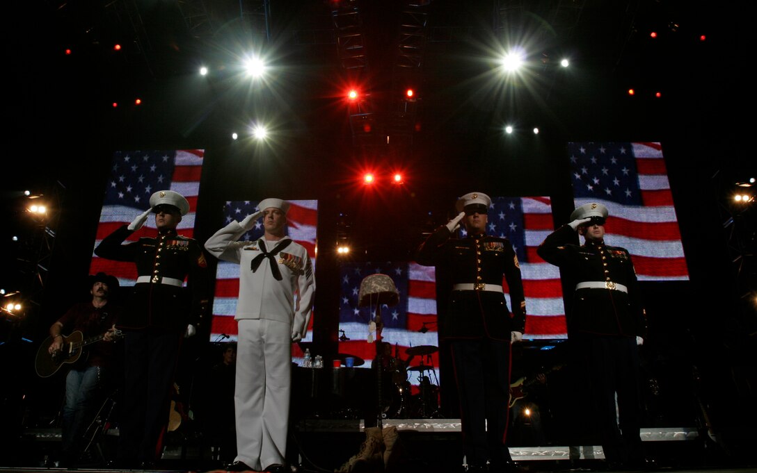 BRISTOW, Va. – Kix Brooks watches as four service members salute the audience during Brooks & Dunn's 2001 hit song "Only in America" at the Nissan Pavilion June 10.
