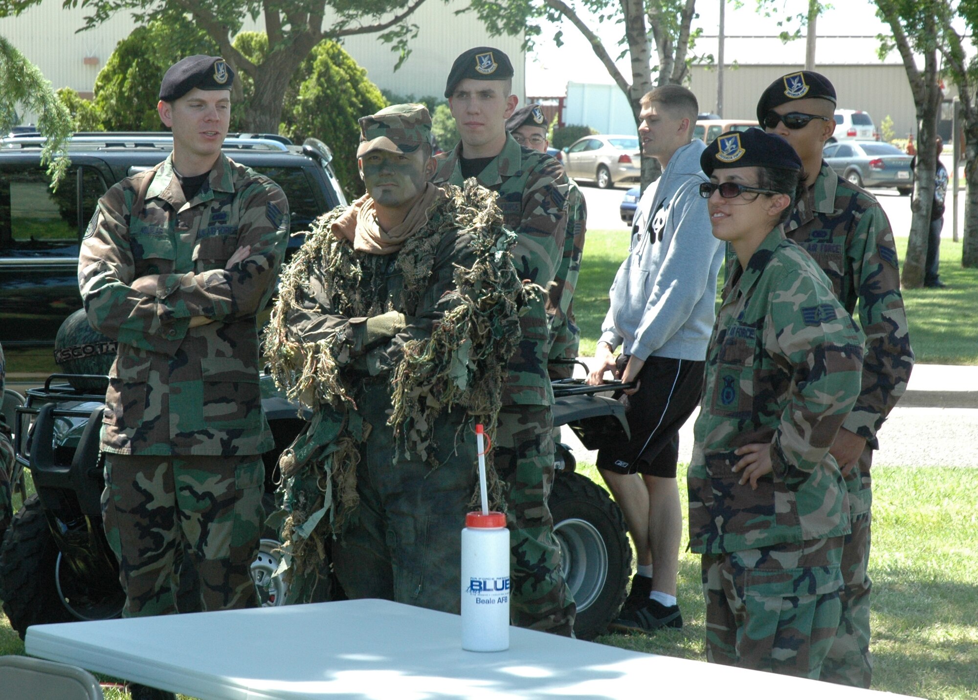 Members of the 940th Security Forces Squadron proudly display their camouflage and concealment capabilities to friends and family at the 940th Air Refueling Wing’s annual family picnic. The picnic took place on the June Unit Training Assembly weekend, and featured food, music, activities for young and old, at the same time it gave wing reservists the opportunity to showcase the unit’s capabilities. (U.S. Air Force Photo/ Staff Sgt. Luke Johnson) 
