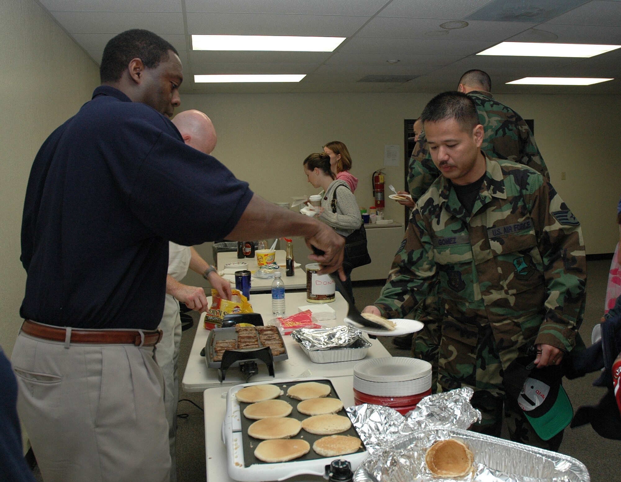 Air Force reservist Master Sgt. Curtis Smith, first sergeant of the 314th Air Refueling Squadron, serves some pancakes to Staff Sgt. Jomar Gomez, a career enhancement journeyman with the 940th Mission Support Group, during the 940th Air Refueling Wing’s First Sergeant’s Council annual free breakfast. The breakfast was held during a Unit Training Assembly weekend at Beale Air Force Base, Calif., and it was open to family and friends of the 940th Air Refueling Wing.(U.S. Air Force Photo/ Staff Sgt. Luke Johnson)
