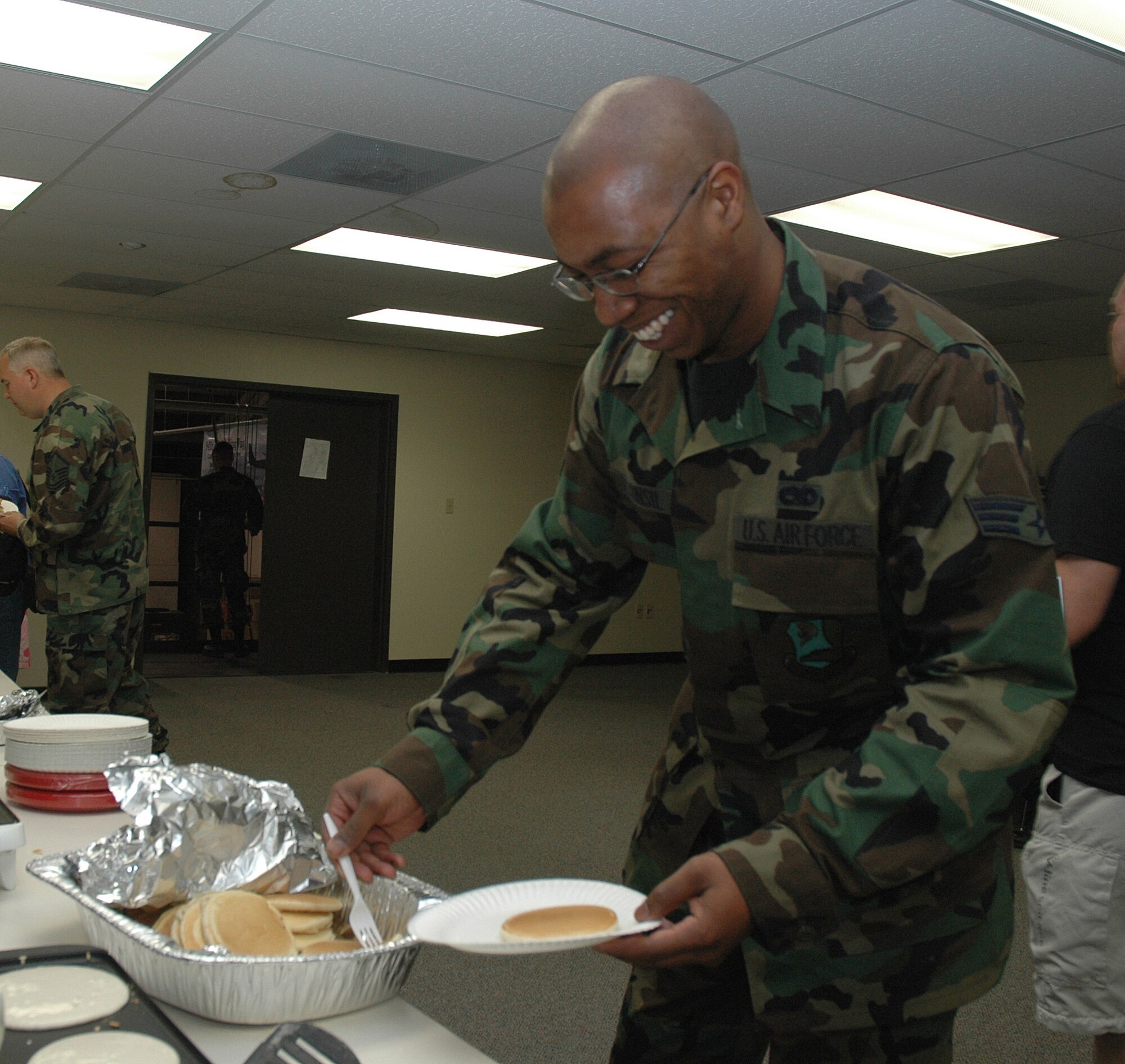 Air Force reservist Senior Airman Anson Tunsil, a crew chief with the 940th Maintenance Group, gladly helps himself to some pancakes during the 940th Air Refueling Wing’s First Sergeant’s Council annual free breakfast. The breakfast, which took place during a Unit Training Assembly weekend at Beale Air Force Base, Calif., was also open to friends and family of the 940th Air Refueling Wing. (U.S. Air Force Photo/ Staff Sgt. Luke Johnson)