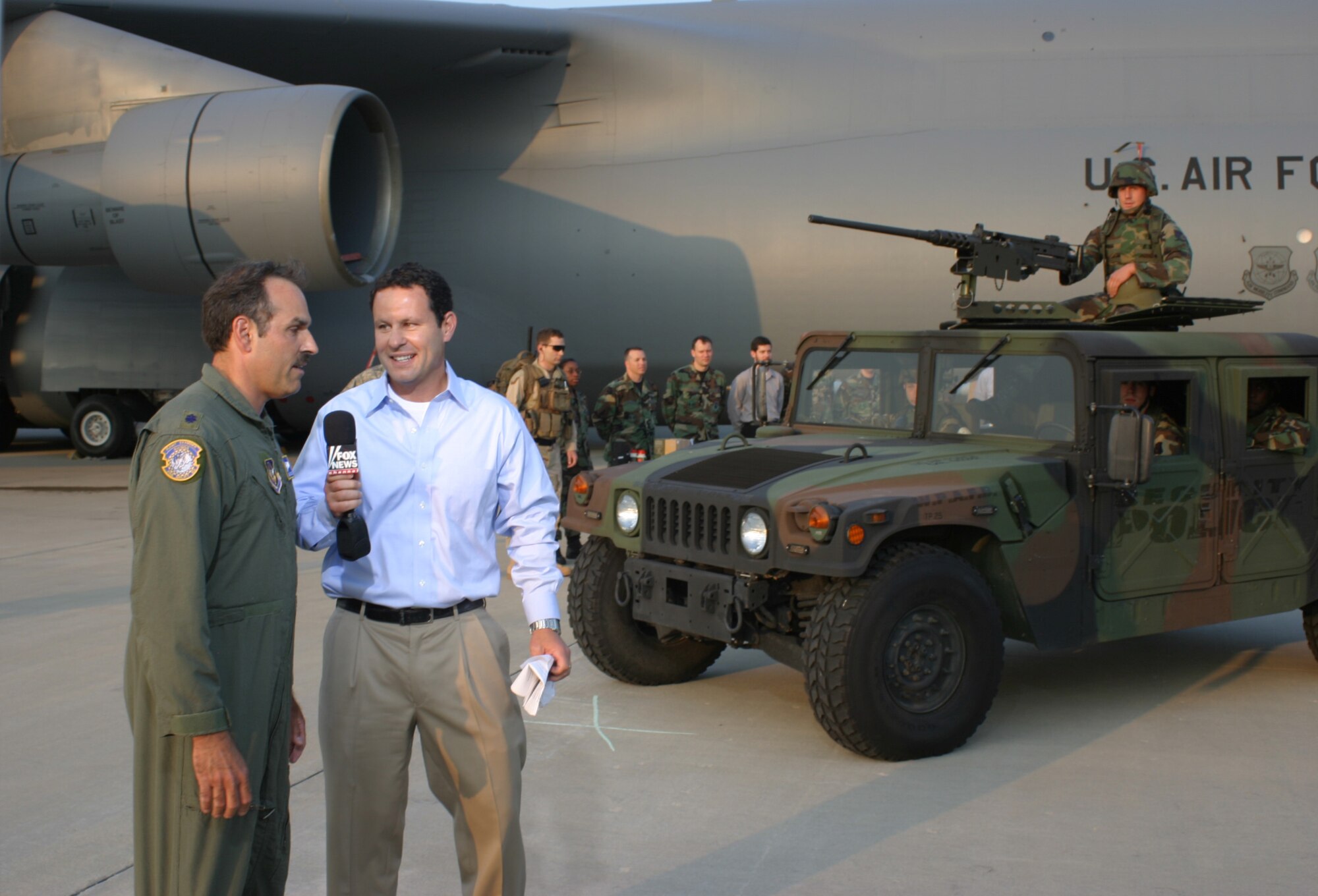 WRIGHT-PATTERSON AFB, Ohio -- Air Force Reserve pilot Lt. Col. David Deluca, from the 89th Airlift Squadron, is interviewed by "FOX and Friends" co-anchor Brian Kilmeade during June 8ths live broadcast from the base.  The C-5 Galaxy aircraft from the 445th Airlift Wing was used for the back drop for the live show. (U.S. Air Force photo/Master Sgt. Doug Moore)