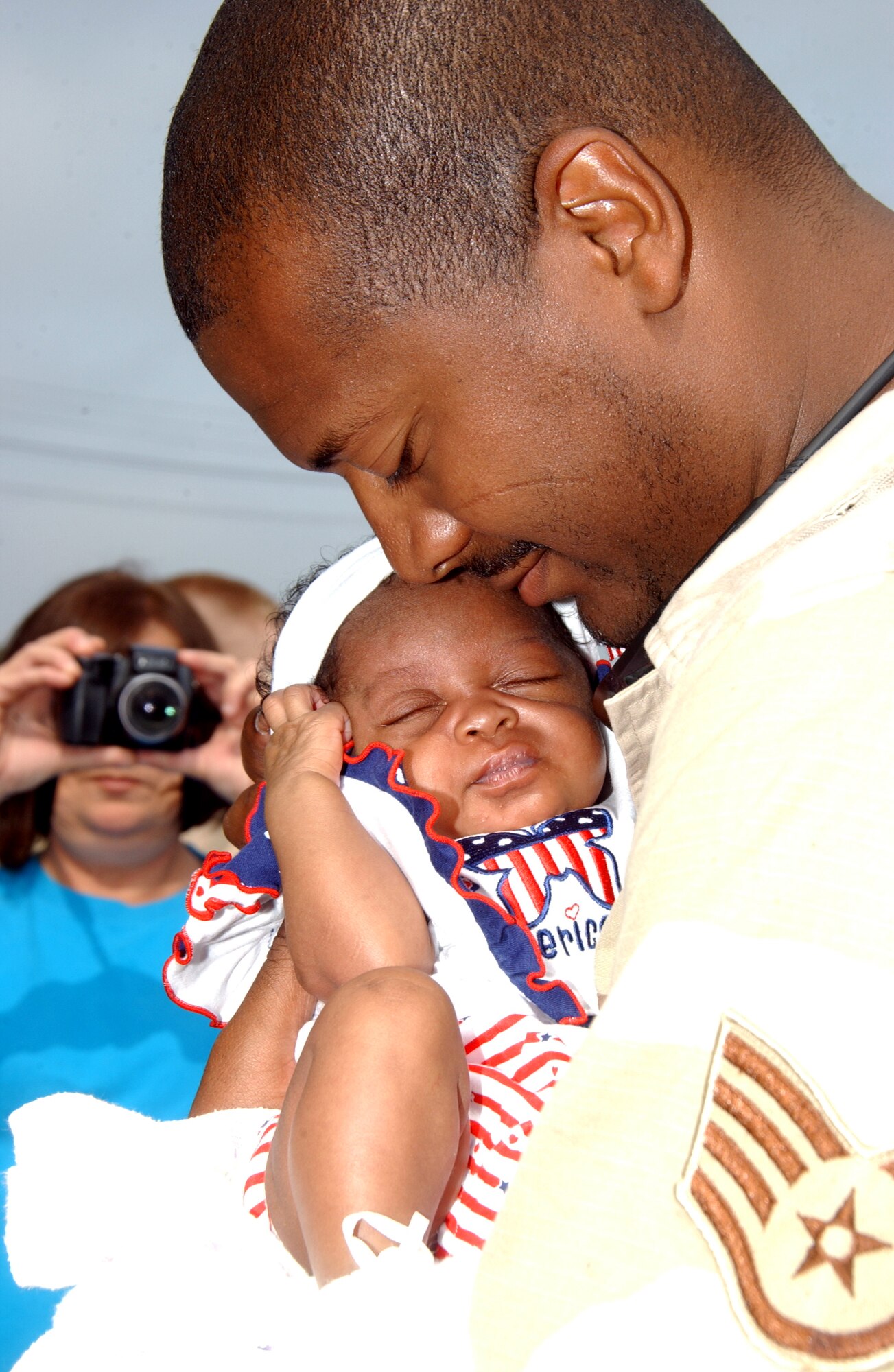 070609-F-0108B-003 MISAWA AB, JAPAN -- Staff Sgt. Danny Goodrum, 35th Aircraft Maintenance Squadron, meets his 5-week-old daughter Maria here on June 9, 2007.  Sergeant Goodrum is part of the Air Expeditionary Force deployment returning from supporting Operation Iraqi Freedom. (U.S. Air Force photo by Senior Airman Robert Barnett)