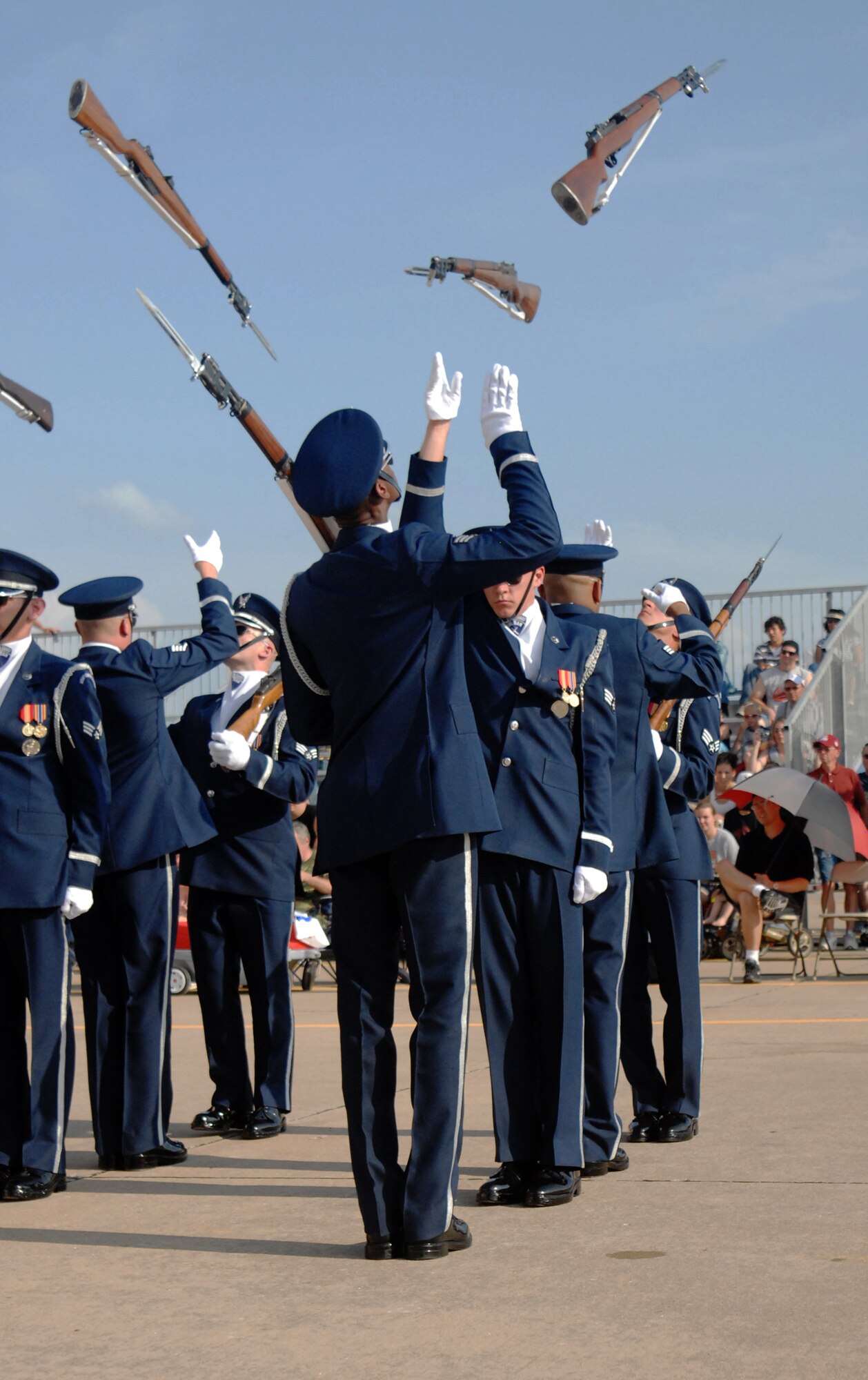 TINKER AFB, Okla. - Members of the Air Force Honor Guard Drill Team perform the back-to-back maneuver where weapons are blindly tossed 8-feet backwards to an awaiting team member. The Drill Team is the traveling component of the Air Force Honor Guard and tours Air Force bases world wide showcasing the precision of today's Air Force to recruit, retain, and inspire Airmen for the Air Force mission. (U.S. Air Force Honor Guard photo by Senior Airman Nestor Bauer)(Released)