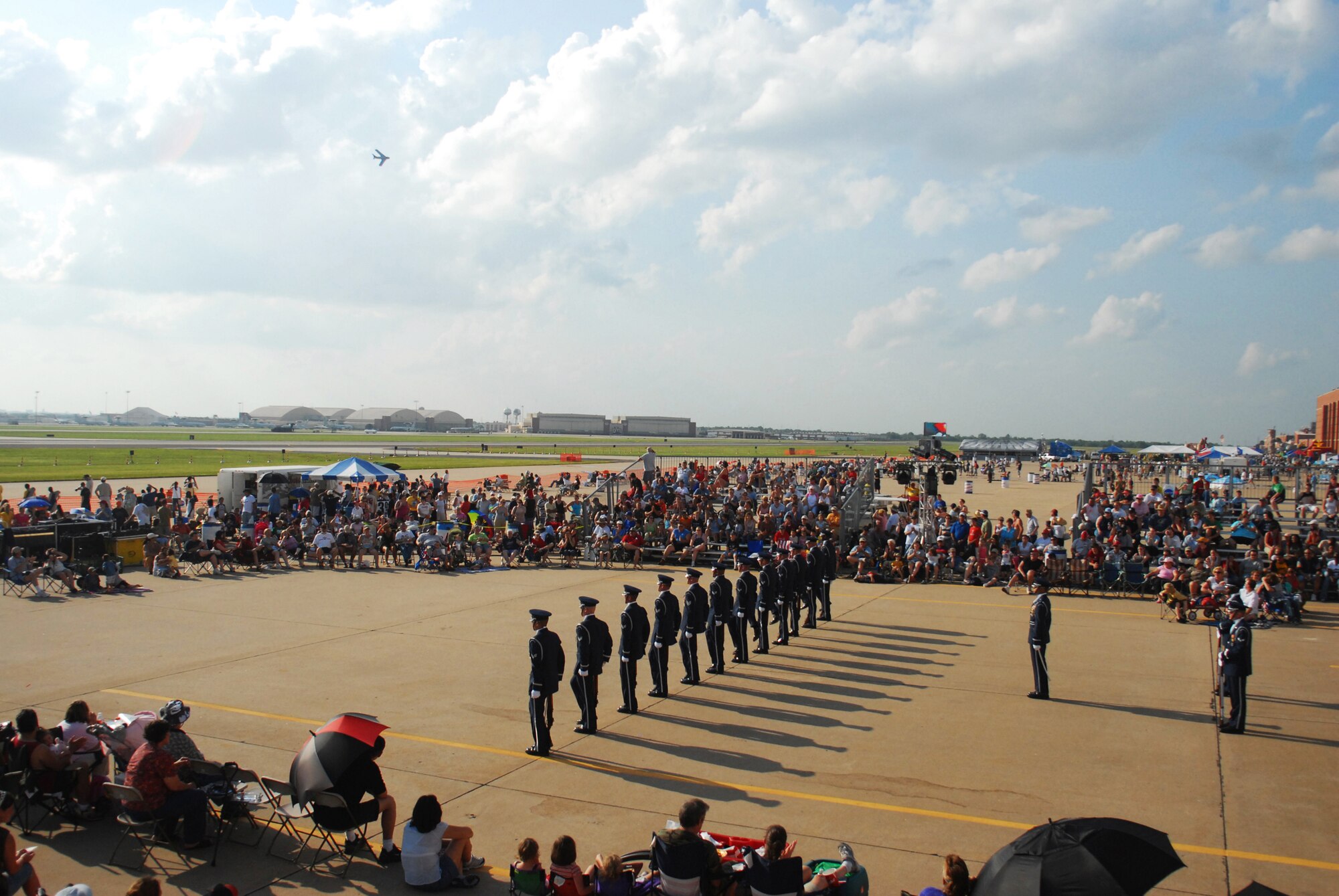TINKER AFB, Okla. - A MiG 17 jet flies overhead as the Air Force Honor Guard Drill Team performs their line formation at Tinker AFB's annual Star Spangled Salute Air Show. The Drill Team performed for the Tinker community on June 9th and 10th, along with the Air Force's Tops in Blue and the Navy Blue Angels. This year's air show events celebrated the Air Force's 60th anniversary and Oklahoma's Centennial. (U.S. Air Force Honor Guard photo by Senior Airman Nestor Bauer)(Released) 