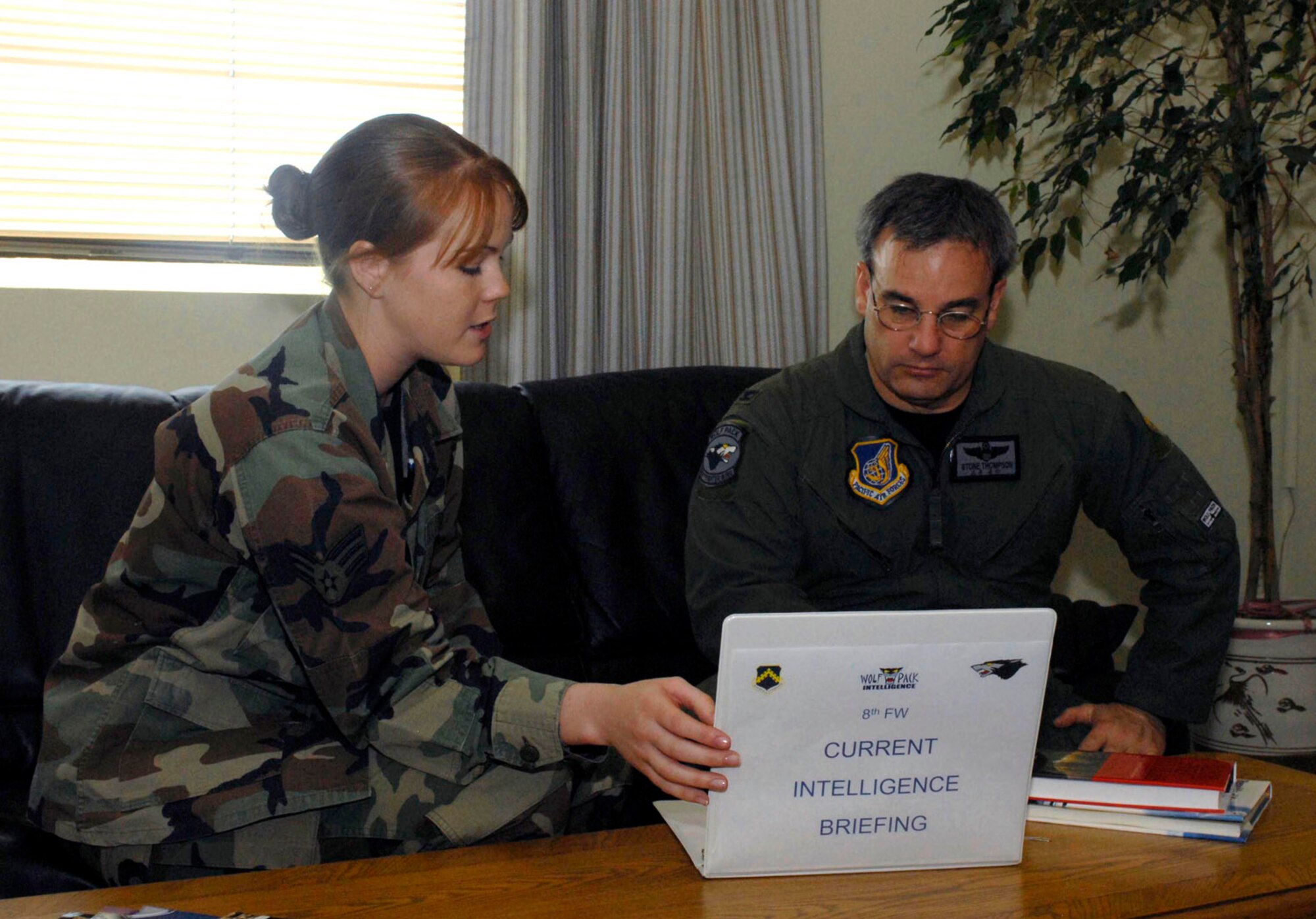 KUNSAN AIR BASE, Republic of Korea-- Senior Airman Chelsea Early, 8th Operations Support Squadron, was selected as the 8th Fighter Wing's Pride of the Pack for the week of June 4. As one of her duties Airman Early briefs Col. Preston "Wolf Two" Thompson, 8th Fighter Wing Vice Commander the current intelligence briefing June 5. (U.S. Air Force photo/Senior Airman Steven R. Doty) 