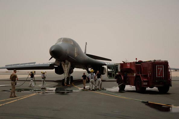 Firefighters with the 379th Expeditionary Civil Engineer Squadron Fire and Emergency Services Flight respond to an emergency on the flightline involving a B-1B Lancer May 31. Their efforts helped save the multi-million-dollar jet. (U.S. Air Force photo by Master Sgt. Ken Stephens)