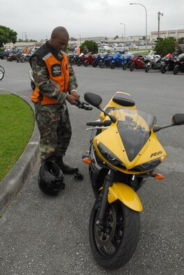 Senior Airman Jay Morgan, 18th Munitions Squadron, prepares to ride in the first annual Motorcycle Group Ride at Kadena Air Base, Japan, June 5. About 75 people participated in the ride which followed a motorcycle all-call where all base riders were given the latest mishap prevention information.
(U.S. Air Force/Airman 1st Class Kasey Zickmund)