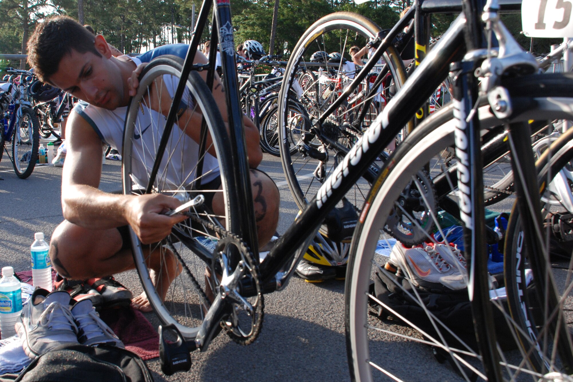 EGLIN AIR FORCE BASE, Fla. -- Jacob John, a 96th Civil Engineer Squadron Airman, makes come final checks on his bike before the start of the 8th Annual My First Tri triathlon at Post'l Point June 9. The triathlon featured a 200-meter swim, 8-mile bike ride and 2.5-mile run. A total of 150 out of the 248 triathletes were participating in their first triathlon. (U.S. Air Force Staff Sgt. Mike Meares)
