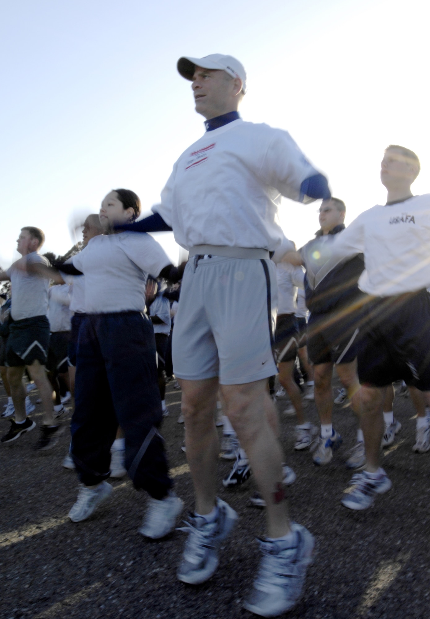 Andy "Iron Man" Holder leads the June Fit to Fight run, doing jumping jacks with Airmen from the 30th Logistics Readiness Squadron.  Mr. Holder developed type I diabetes later in life, and chose to become an Iron Man athelete and motivational speaker. (U.S. Air Force photo/Airman Jonathan Olds)