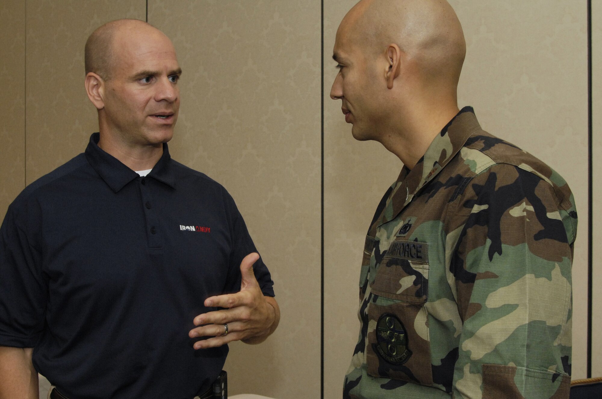 Maj. Christopher De Los Santos speaks with Andy "Ironman" Holder at the Health and Welliness Fair in the Pacific Coasl Club June 6. Andy Holder is an inspirational speaker who was diagnosed with type I diabetes in 2005.  Since then he's decided to take control of his diabetes and inspire others by becoming an Ironman competitor which requires him to swim 2.4 miles, bike 112 miles and run a full marathon of 26.2 miles. (U.S. Air Force photo/Airman 1st Class Nichelle Griffiths)