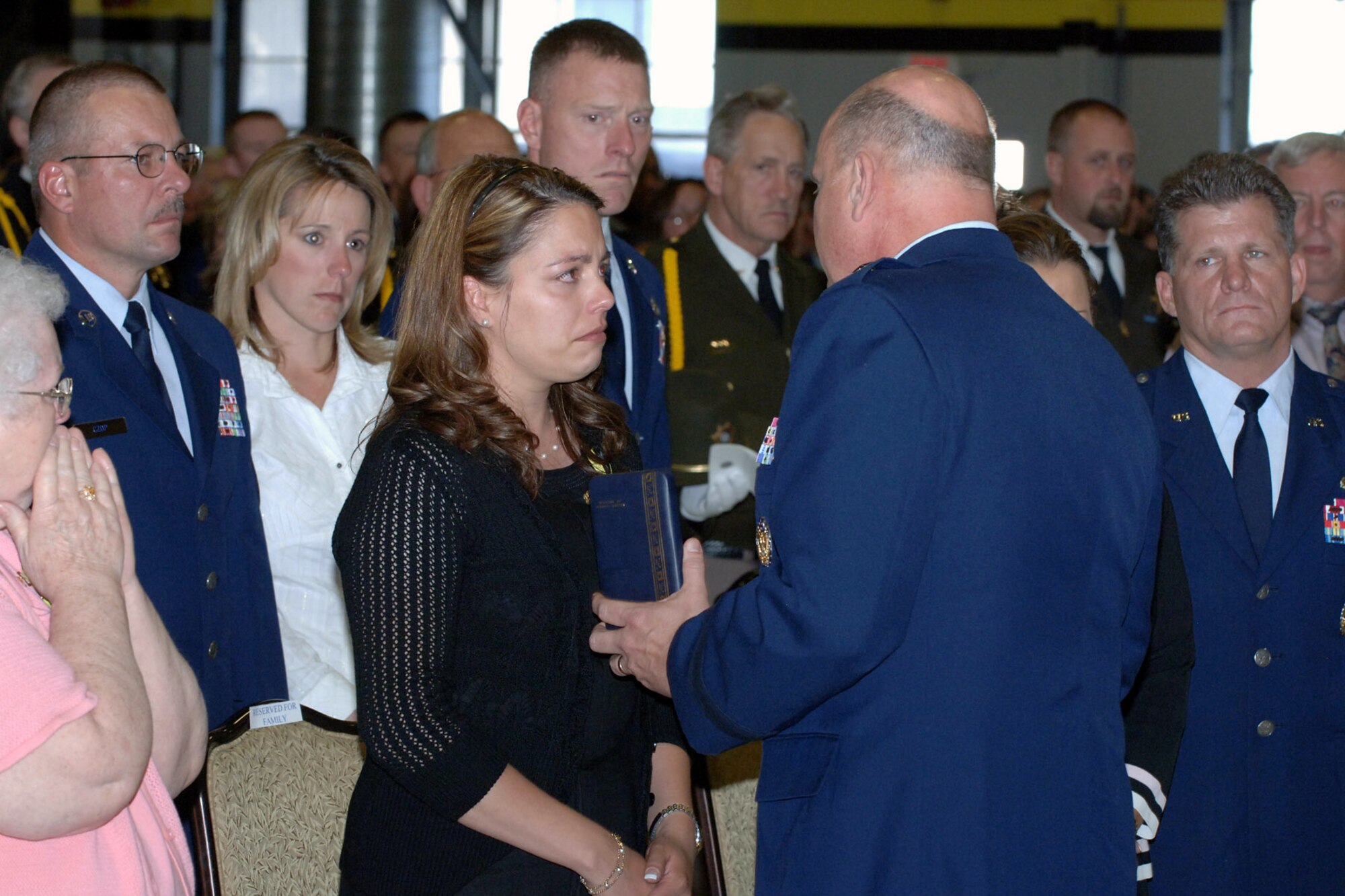 Brig. Gen. Dana Simmons presents a Purple Heart to Danielle Balmer during a memorial tribute to her husband, Tech. Sgt. Ryan Balmer, June 8 at Hill Air Force Base, Utah.  Sergeant Balmer, deployed to Kirkuk Air Base, Iraq, was killed June 5 by an improvised explosive device that detonated near his convoy vehicle.  Sergeant Balmer was a special agent assigned to the Air Force Office of Special Investigation Detachment 113 at Hill.  General Simmons is Air Force Office of Special Investigation commander.  (U.S. Air Force photo/Todd Cromar)