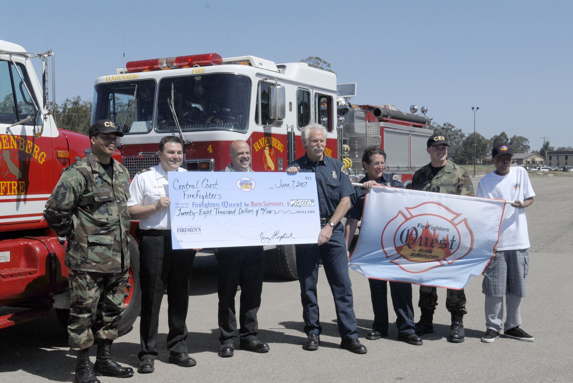 Vandenberg’s Fire Department presents a check of $28,000 to Firefighters Quest for Burn Survivors during a ceremony at the parade grounds June 7. The money, raised at Avila Beach Golf Resort April 16, will fund local burn centers and foundations, and benefit burn survivors and their families. (U.S. Air Force Photo/Airman 1st Class Matthew Plew)