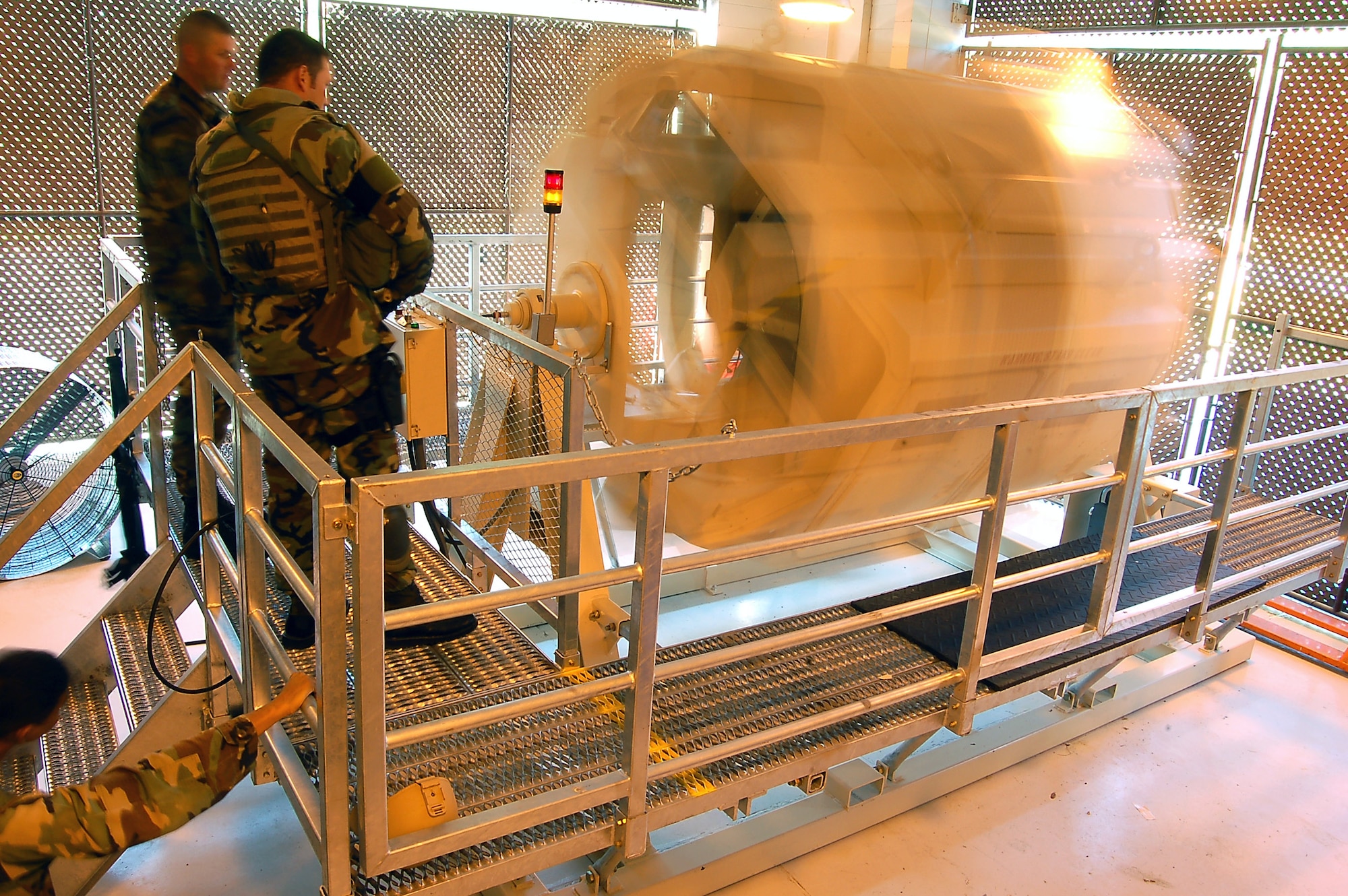 Several security forces Airmen observe fellow Airmen training in the new Humvee Egress Assistance Trainer, or HEAT, at the 820th Security Forces Group Training and Technology Center at Moody Air Force Base, Ga.  The HEAT realistically simulates a vehicle rollover, allowing crew members to prepare for such a crisis in a safe environment.  (U.S. Air Force photo/Tech. Sgt. Parker Gyokeres) 